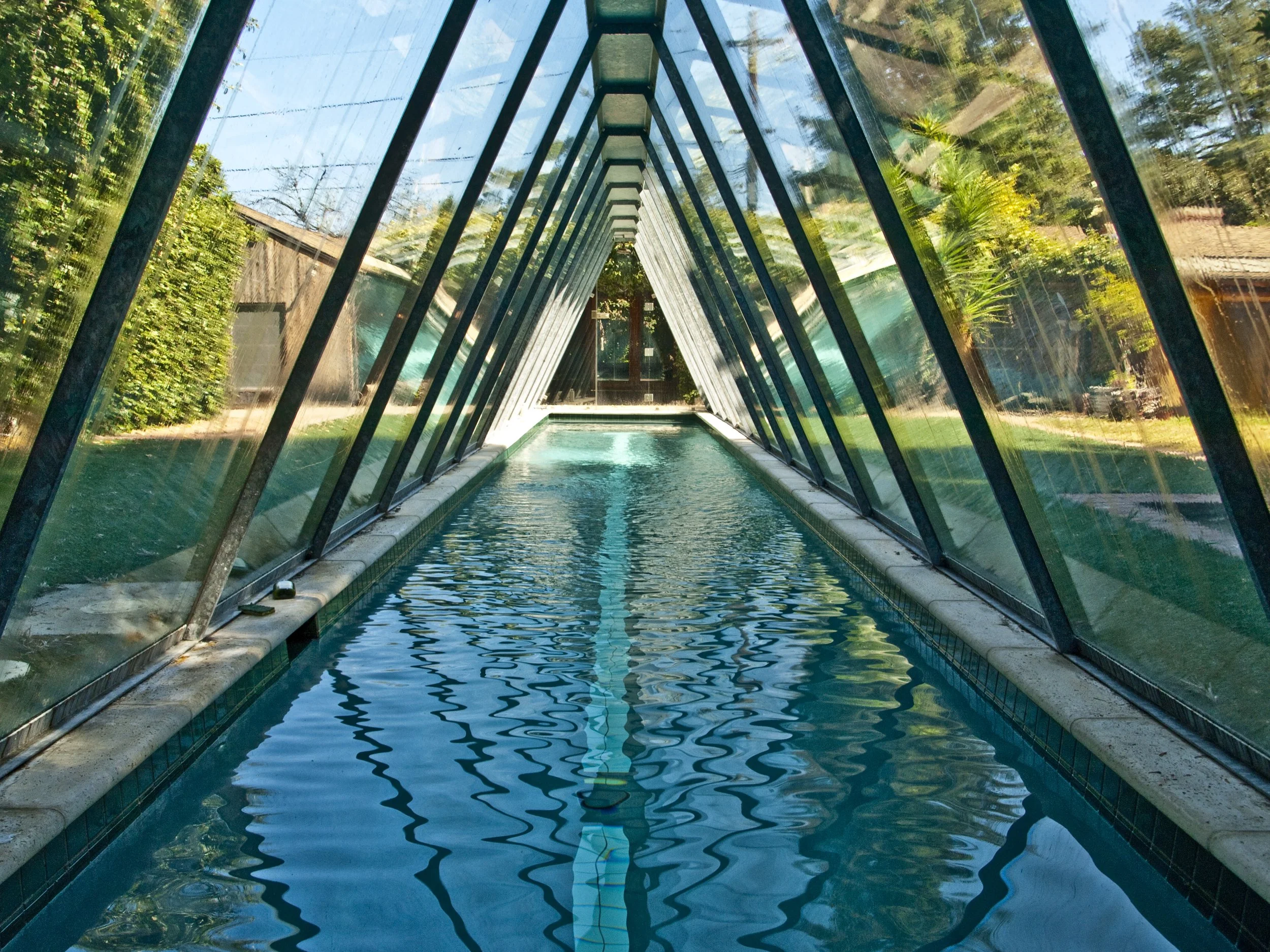 Presented by Missig Team, a real estate team at Berkshire Hathaway HomeServices California Properties in Beverly Hills and Los Angeles. A celebrity compound with stories of past lore. A triangular shaped glass-enclosed swimming pool, with a rustic mo