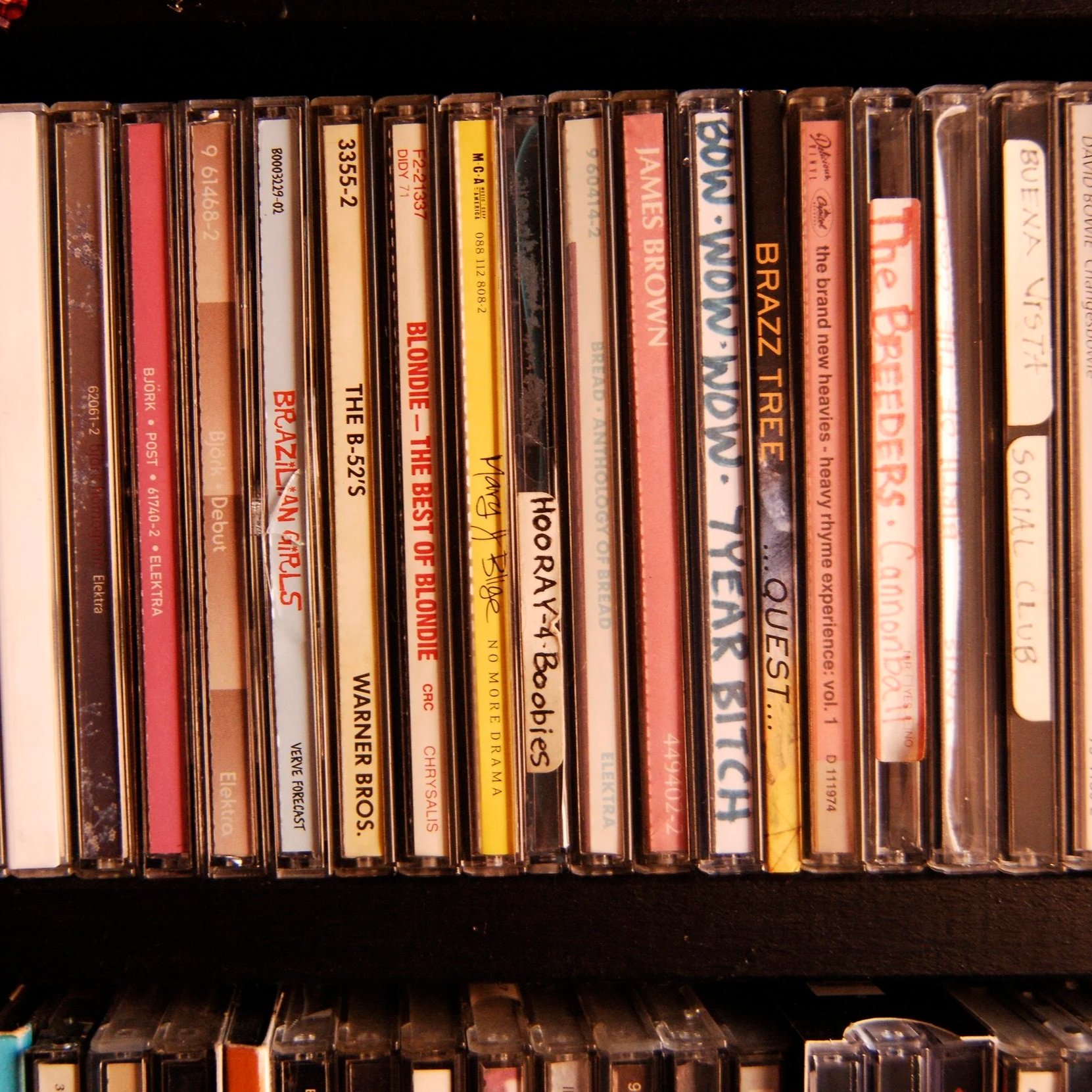 Collection of cassette tapes with various titles and artists on their spines, including Blondie, James Brown, Queen, and The B-52s.