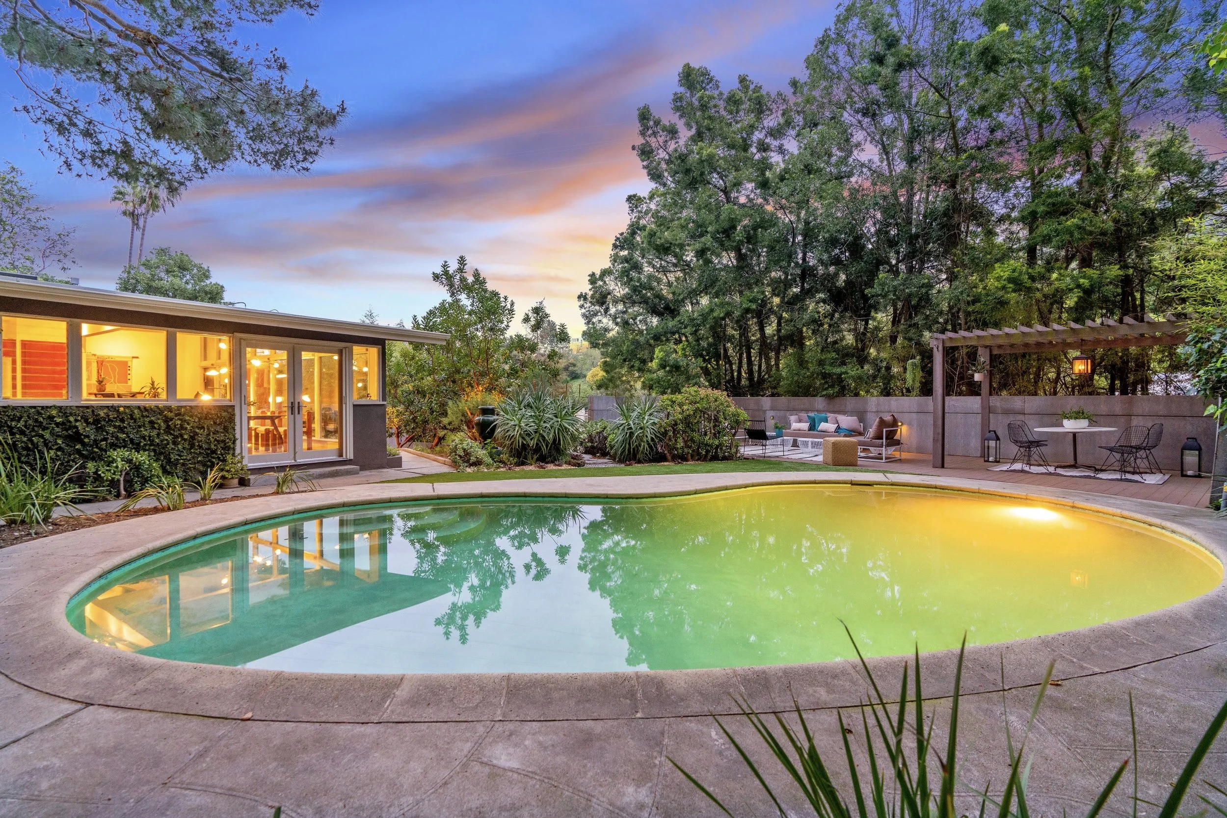 The Rodenberg Residence, a 1954 Mid-Century Modern post and beam home in Laurel Canyon, Hollywood Hills. Features 2 bedrooms, 2 bathrooms, classic kidney-shaped pool, large entertainment deck, open floor plan with walls of glass, chefβs kitchen with