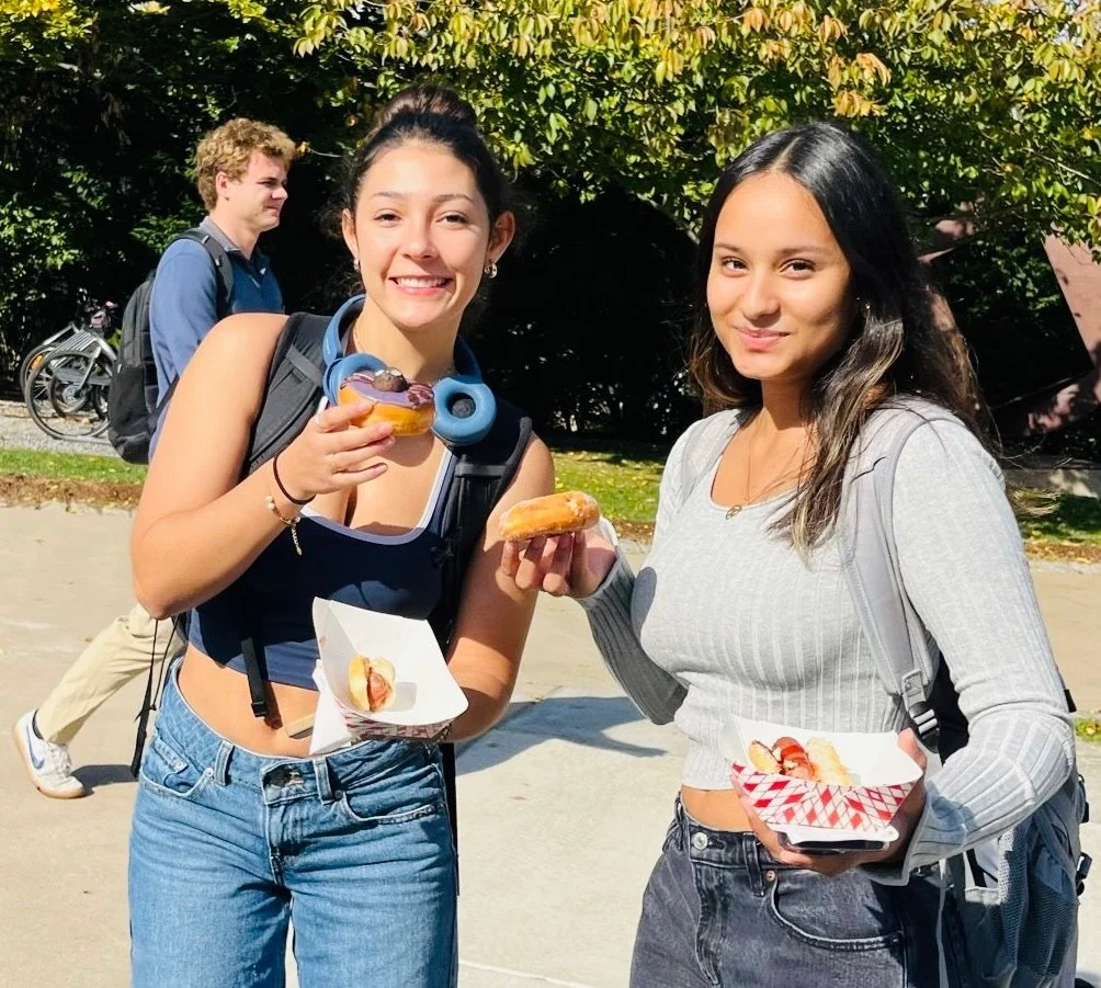 College students with donuts at Donuts and Democracy table.