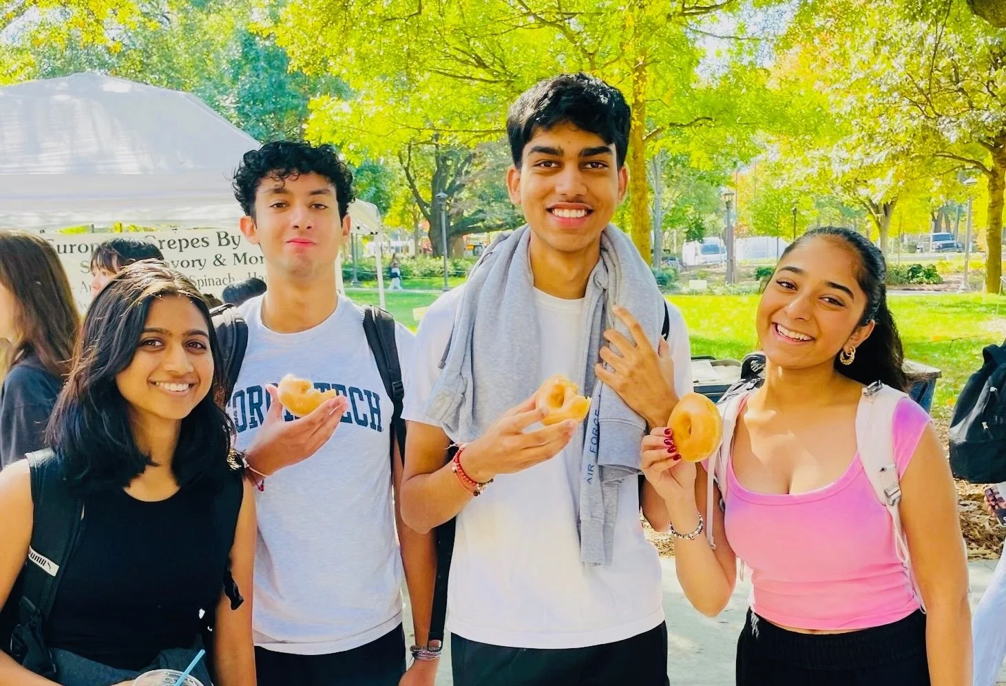 College students with donuts at Donuts and Democracy table.