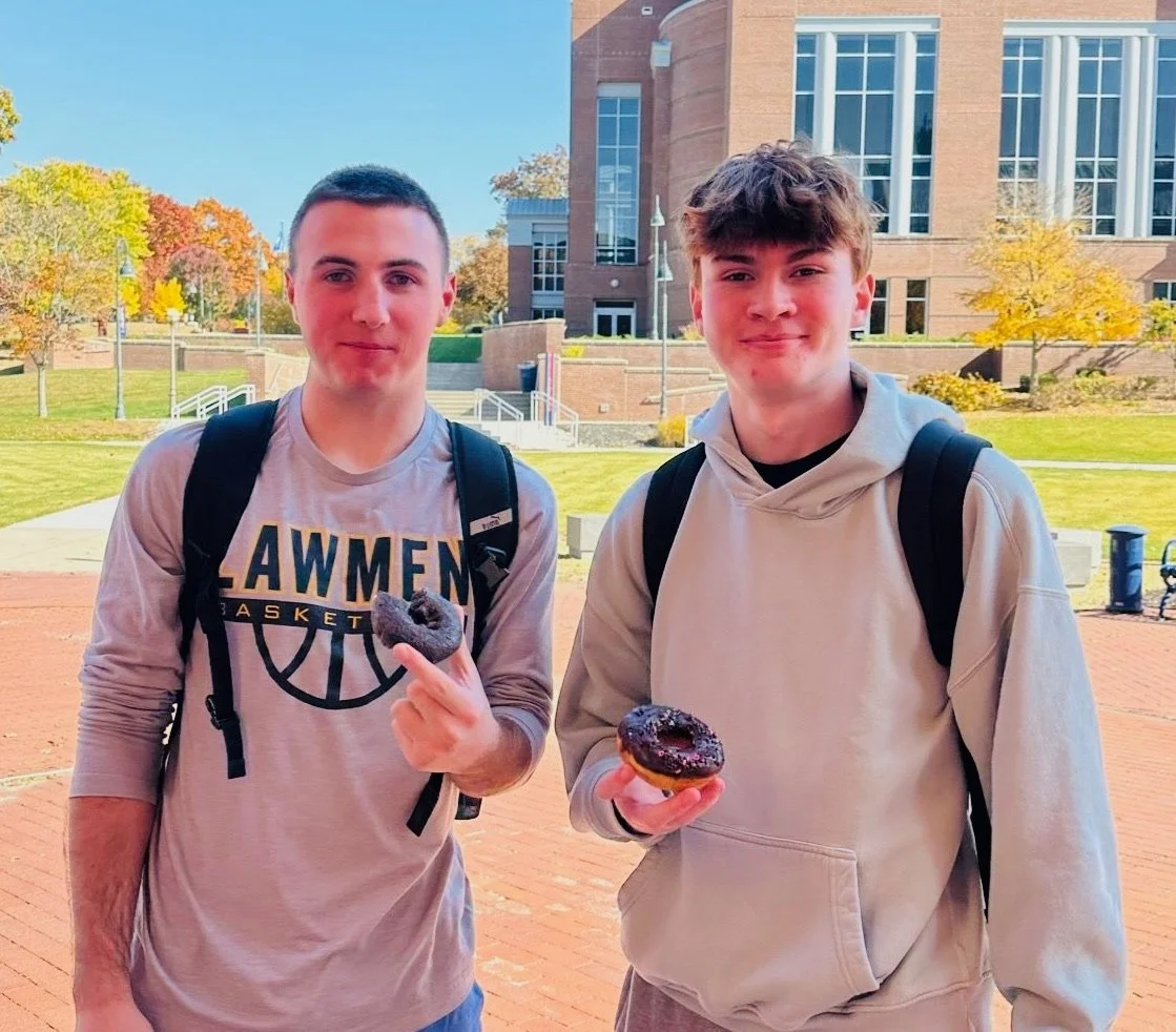 College students with donuts at Donuts and Democracy table.