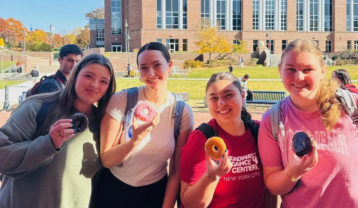 College students with donuts at Donuts and Democracy table.