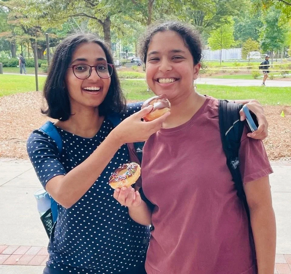 College students with donuts at Donuts and Democracy table.