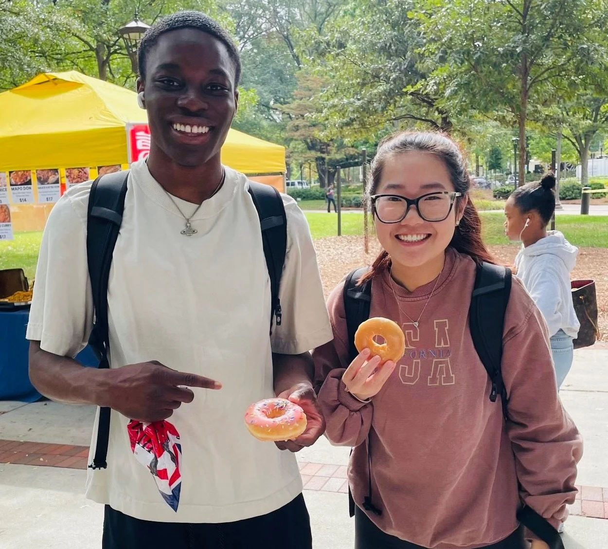 College students with donuts at Donuts and Democracy table.