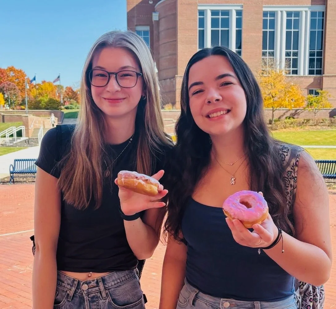 College students with donuts at Donuts and Democracy table.
