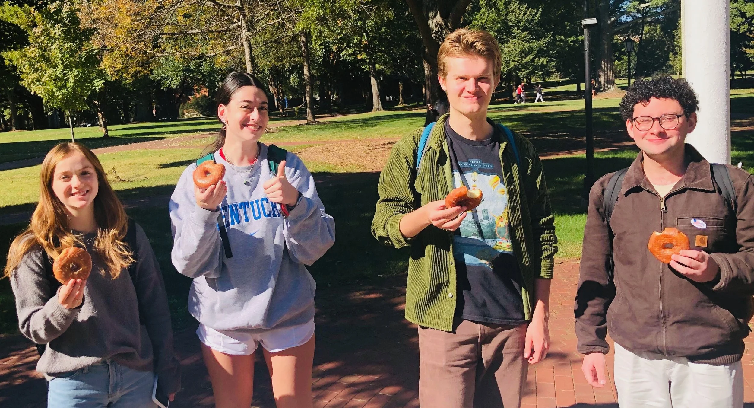 College students with donuts at Donuts and Democracy table.