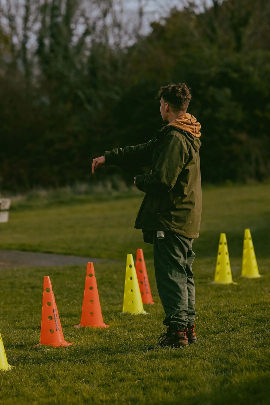 Elliot, a gundog instructor in Cornwall, teaching a heelwork activity during a dog training class in Falmouth
