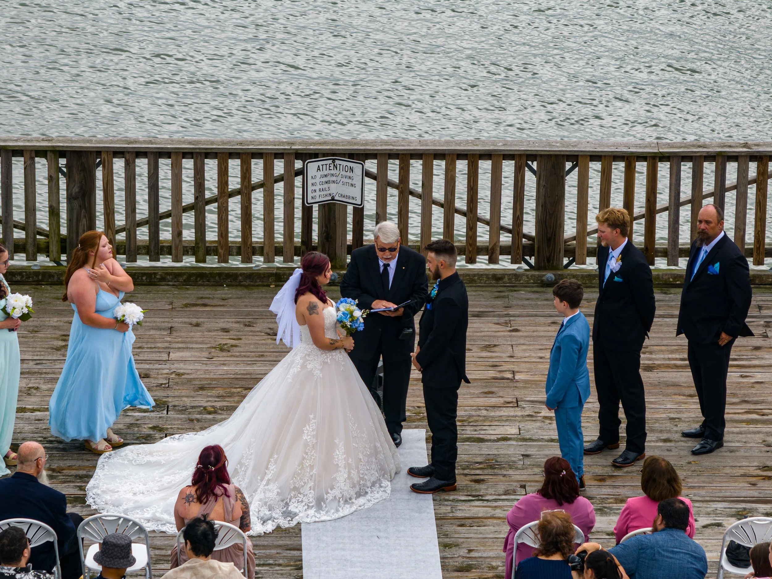 Drone photography of a wedding, on a dock, at Buckroe Beach in Hampton, VA