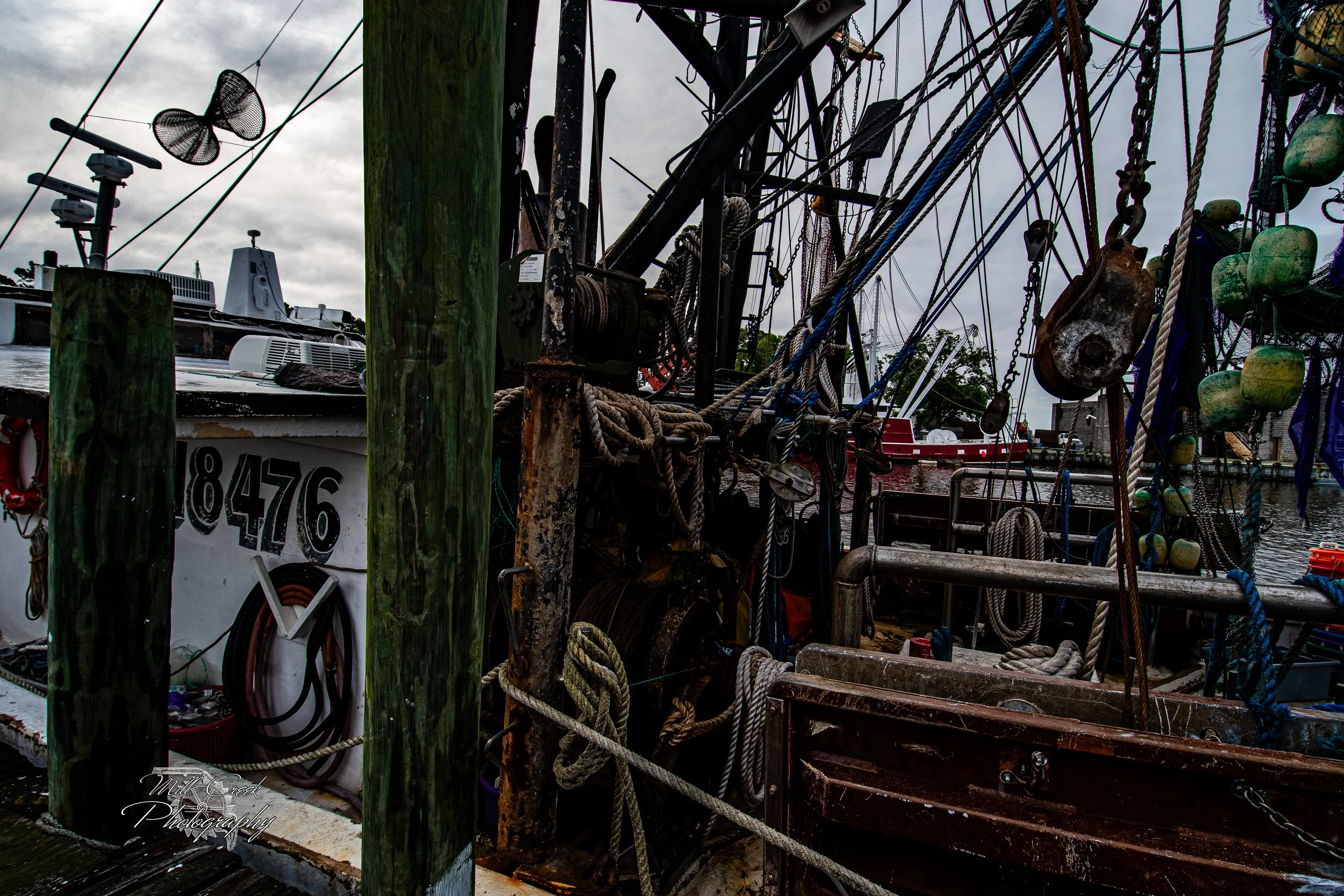"Tools of the Trade"
A close-up of nets, ropes, pulleys, and weathered rigging aboard a shrimp boat, capturing the grit and character of life on the water.