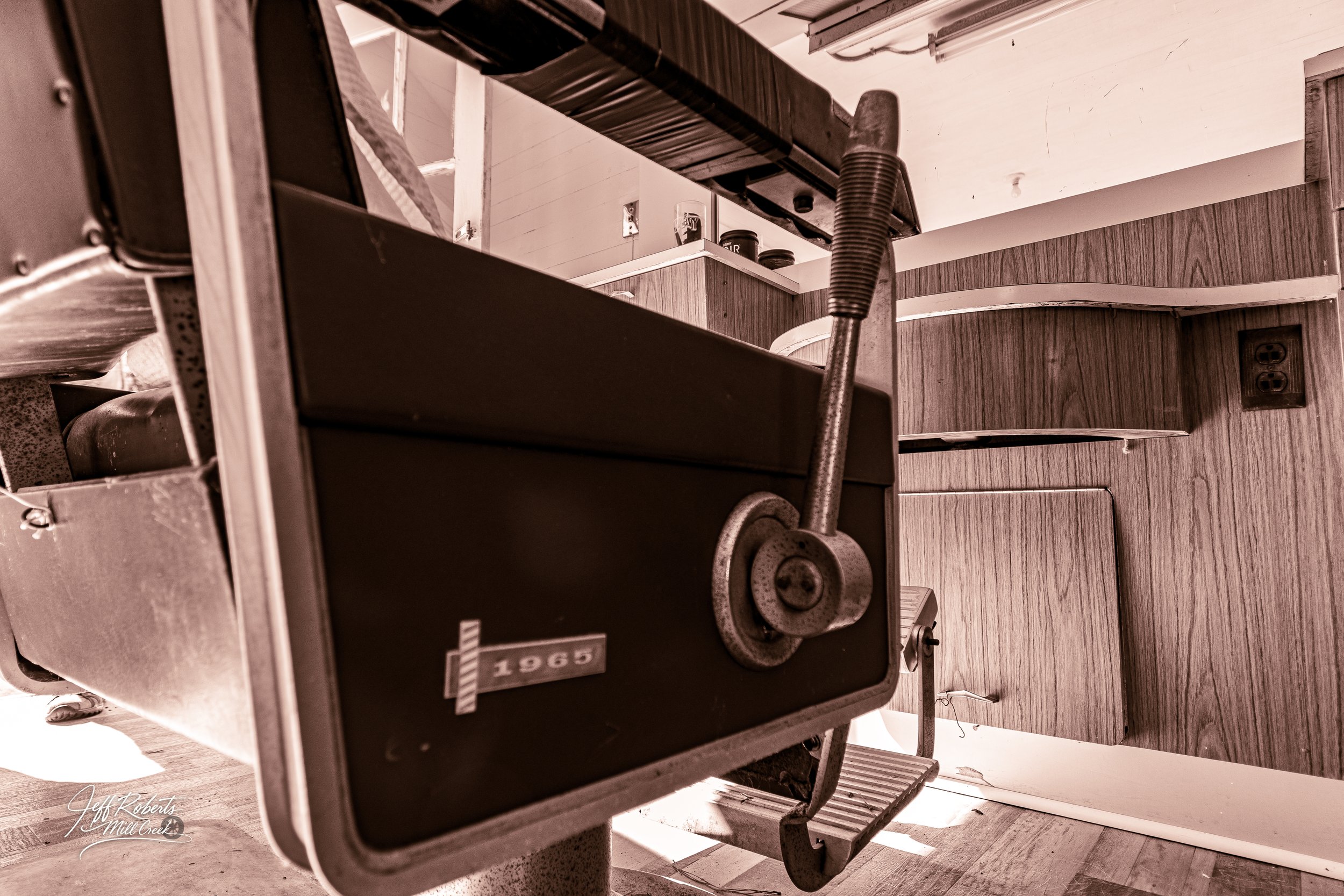 Vintage barber chair with numbered tag in an old barber shop.