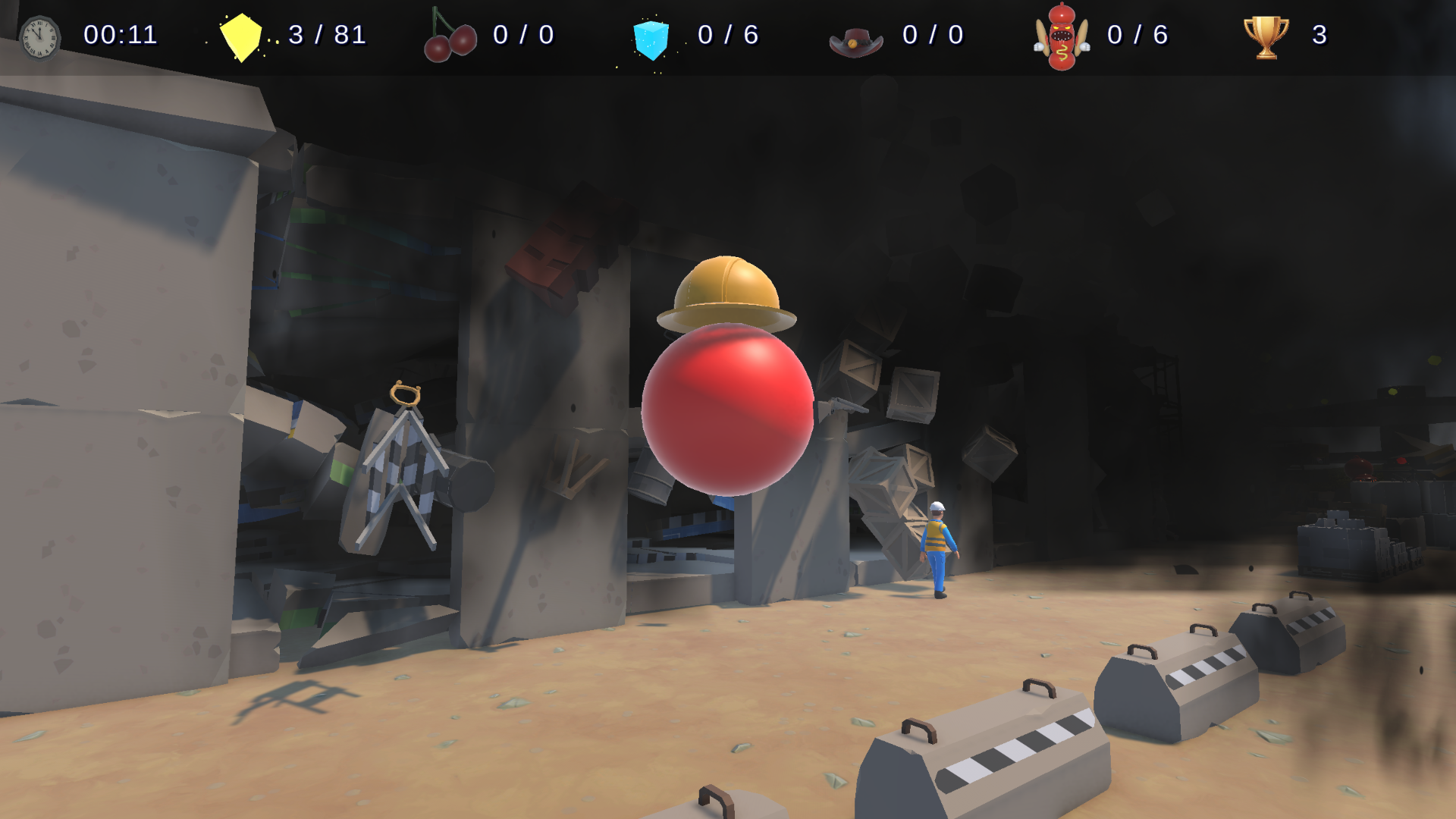 Video game scene with a construction worker character walking near a damaged wall with debris and crates, featuring a large red sphere with a yellow helmet floating above it in a dark environment.