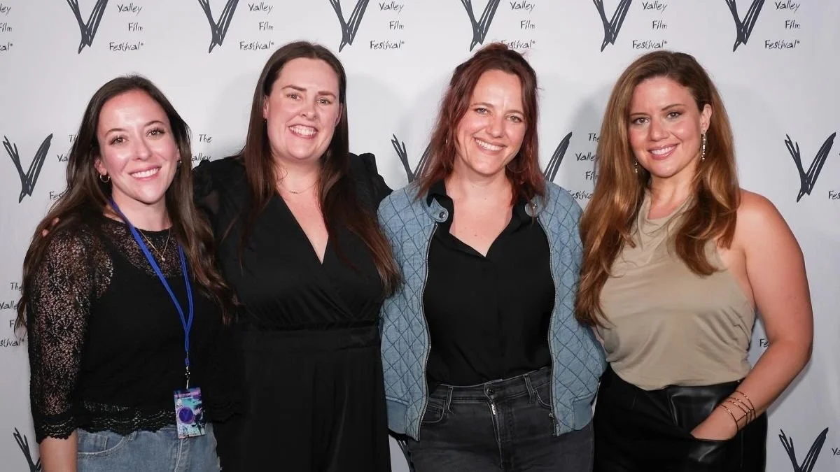 Four women smiling and posing together at the Valley Film Festival, standing in front of a step-and-repeat backdrop with the festival's logo.