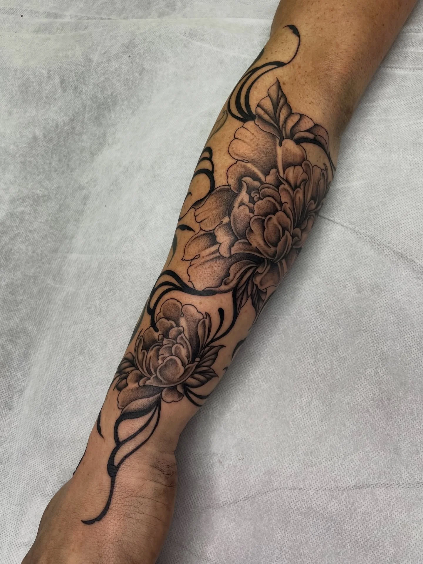 Finished off Sinead&rsquo;s forearm adding in more florals to the healed chrysanthemum . Thank you I loved doing this one! 🖤 DM to book in, made at @westside_tattoo_mermaid_beach
