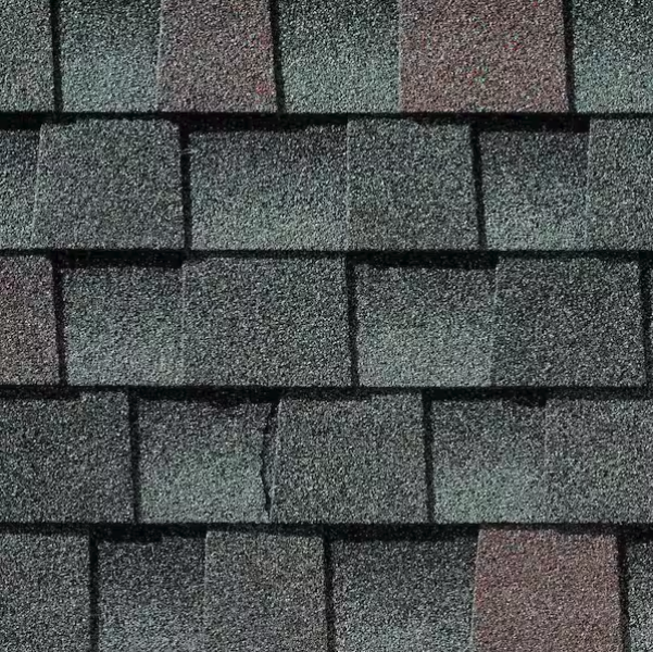Close-up of gray asphalt shingles on a roof.