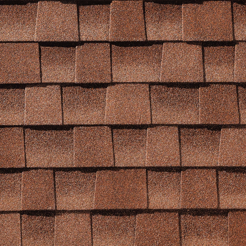 Close-up of reddish-brown asphalt roof shingles arranged in a layered pattern.