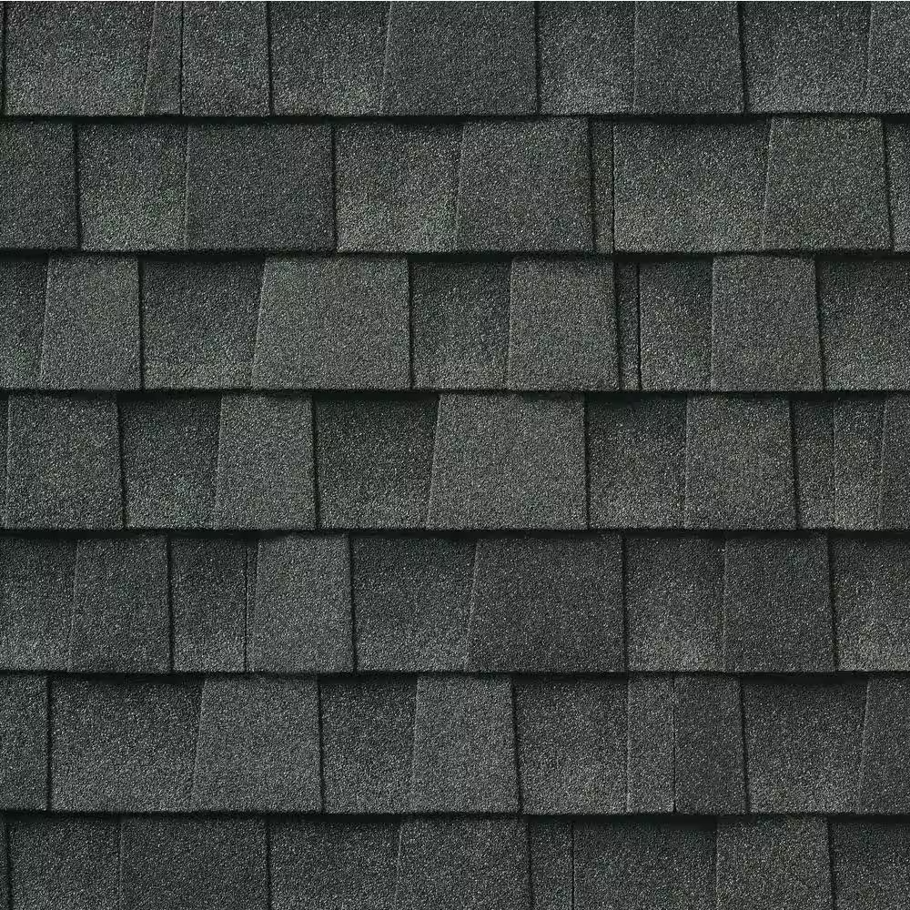 Close-up of black asphalt roofing shingles arranged in horizontal rows.