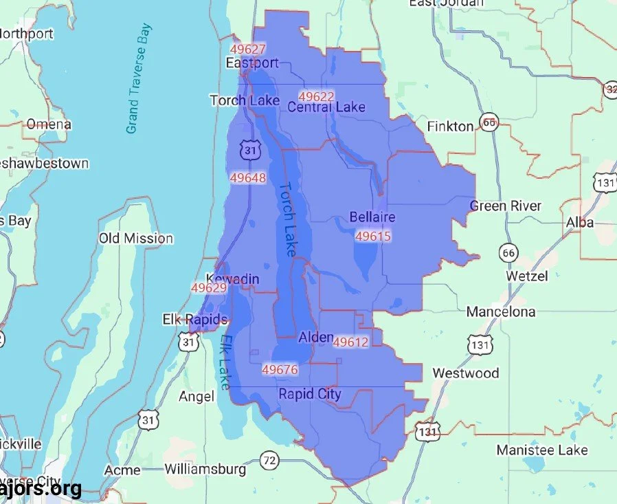 Map showing the boundaries of several towns and lakes in Michigan, including Torch Lake, Central Lake, Bellaire, Alden, and Rapid City, with major roads and zip codes marked.