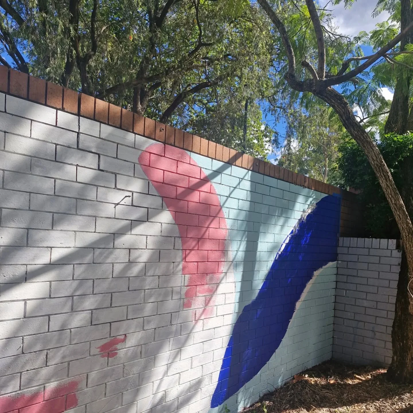 Mitchelton State High School installation with Griffith University LiveArt. First day of painting was mainly about priming the red brick wall and starting to put some colour down.