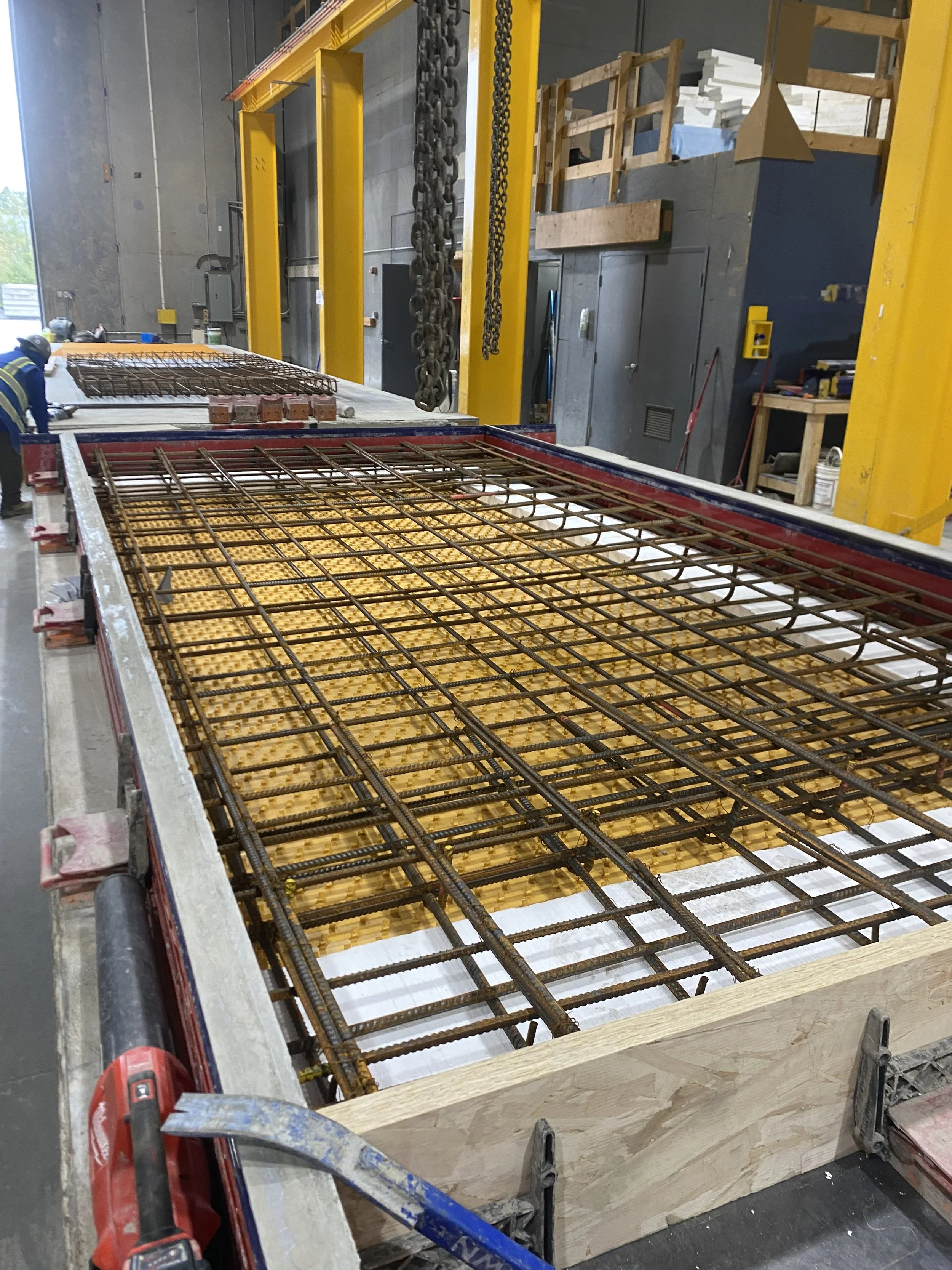 Wooden concrete frame ready to have concrete poured inside, with rebar installed for support.