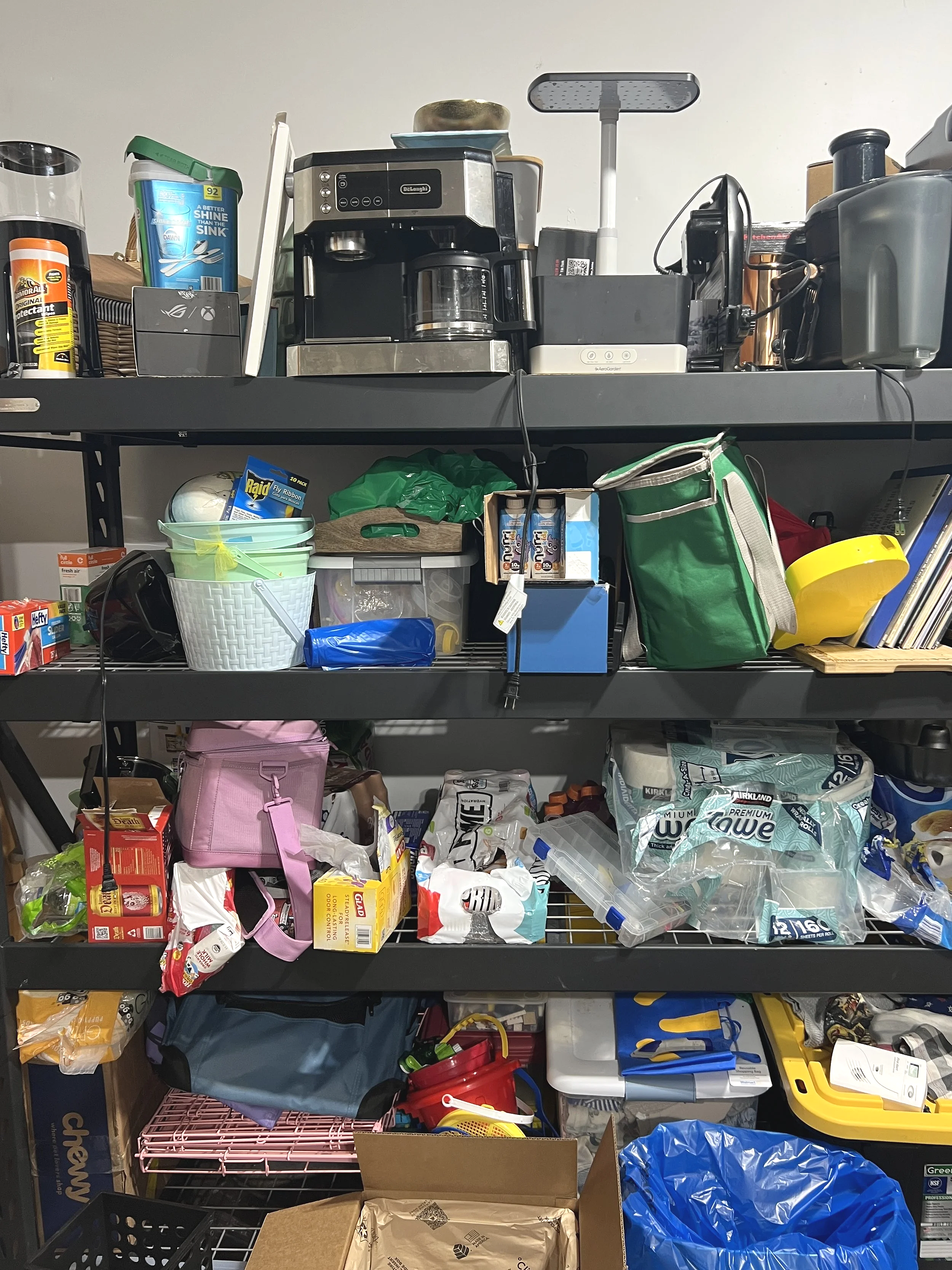 Crowded garage shelving before professional organizing