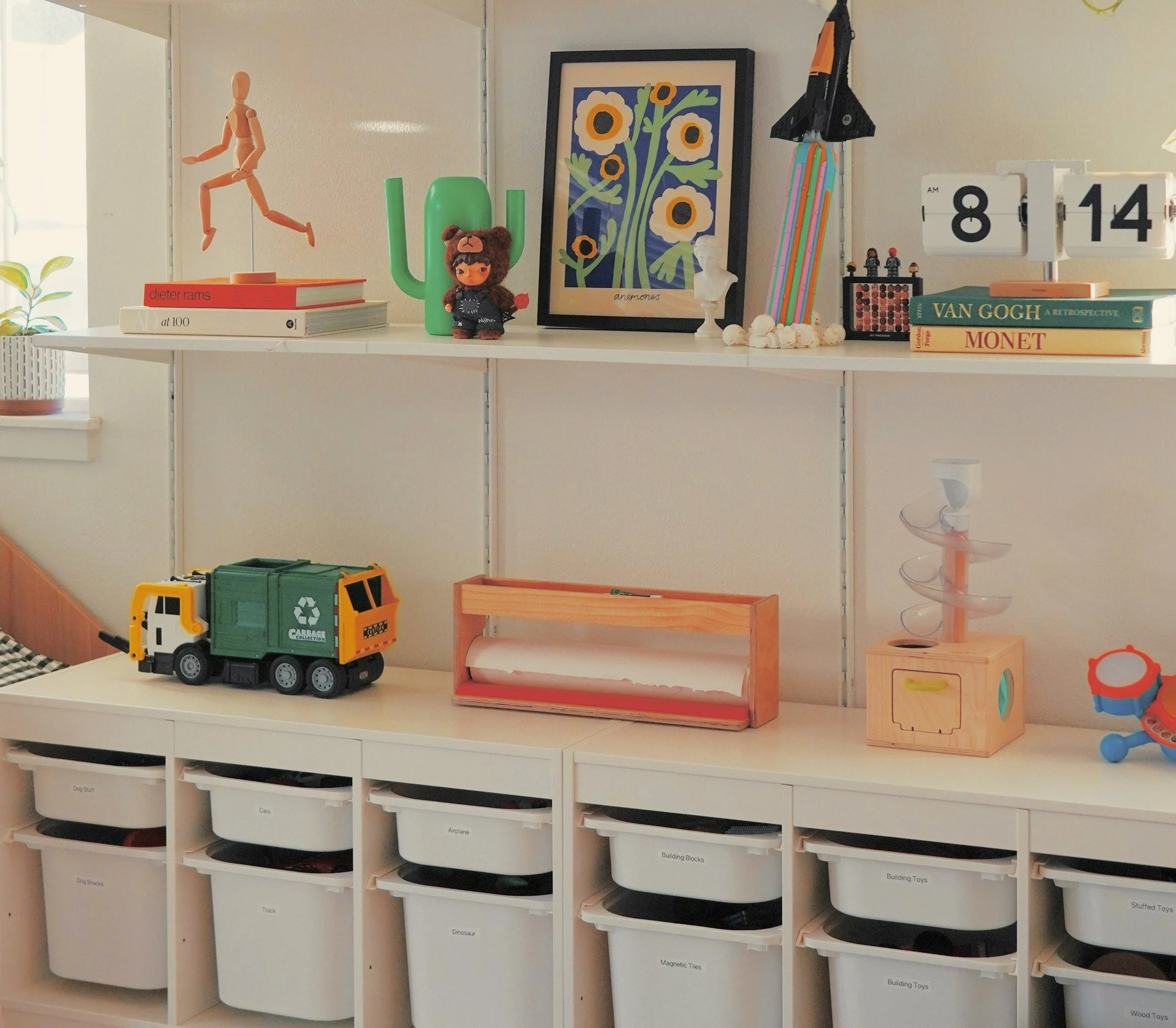 Children’s playroom organization with labeled storage cubes and neatly arranged toys and books.