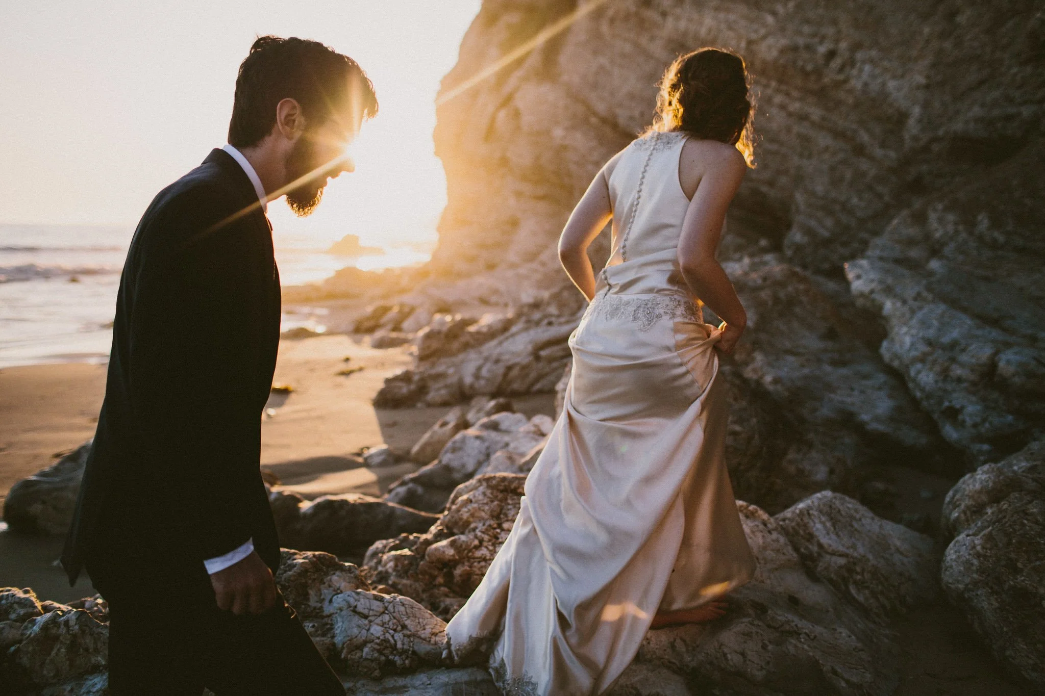 Bride and groom adventure on a beach at sunset in Santa Barbara, California Wedding