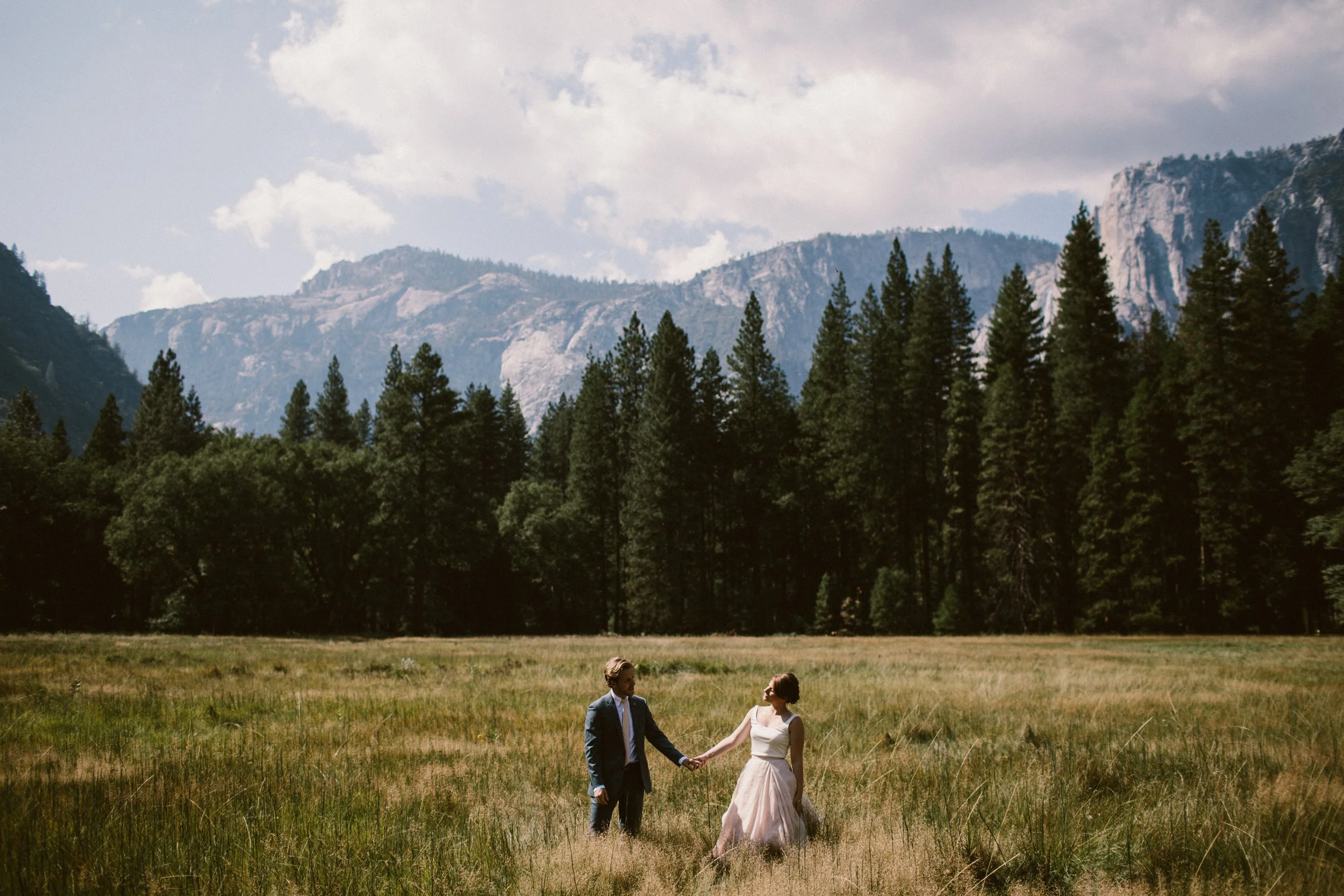 Couple holding hands in the mountains on their wedding day