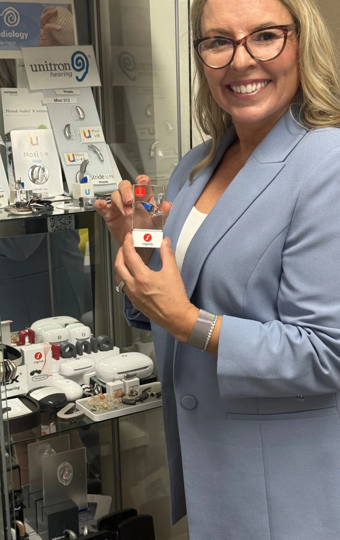 Audiologist with small hearing aid