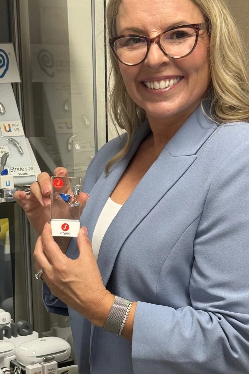 Audiologist with small hearing aid