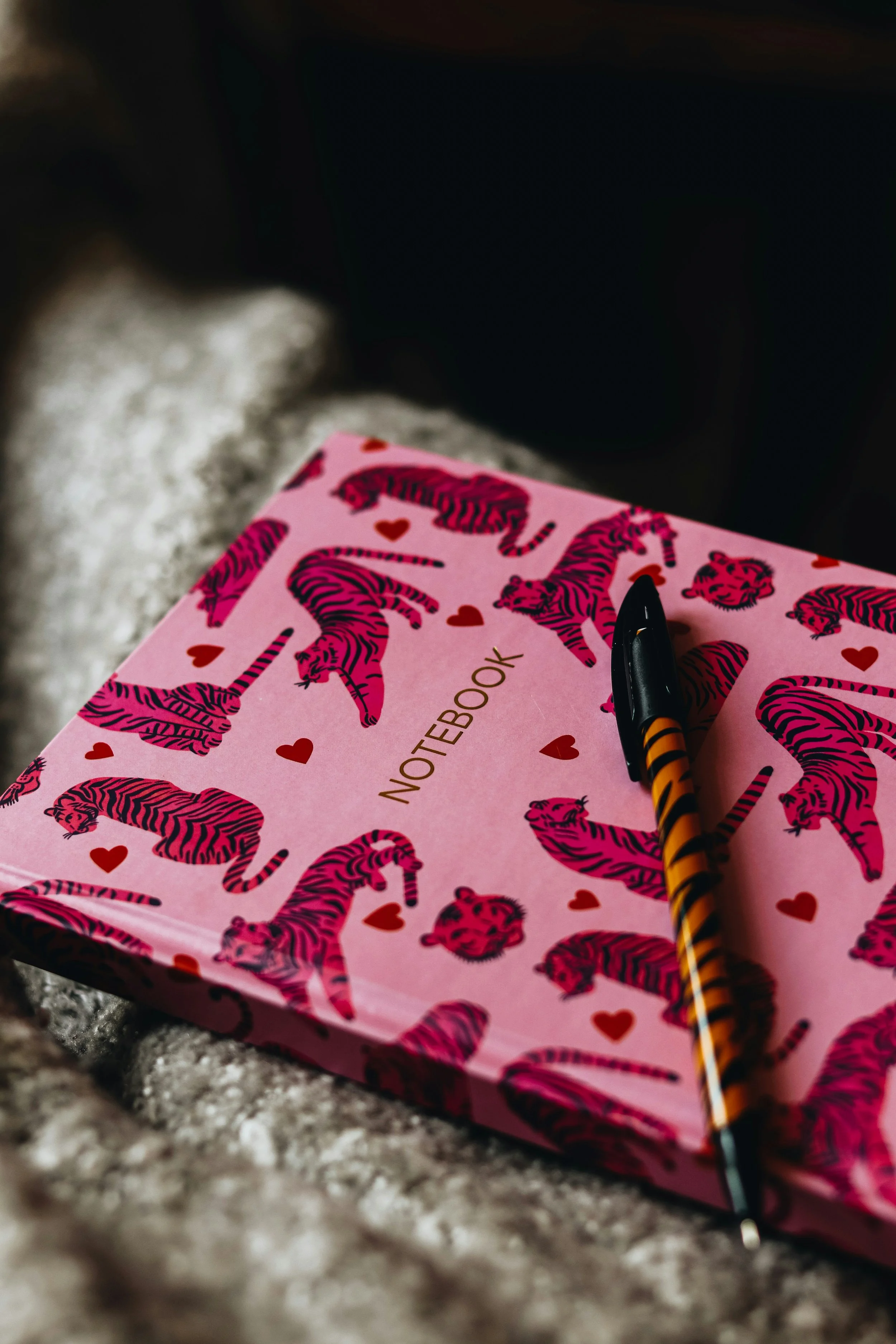 Pink notebook with pink animals on it, representing the therapist's take on the movie Legally Blonde