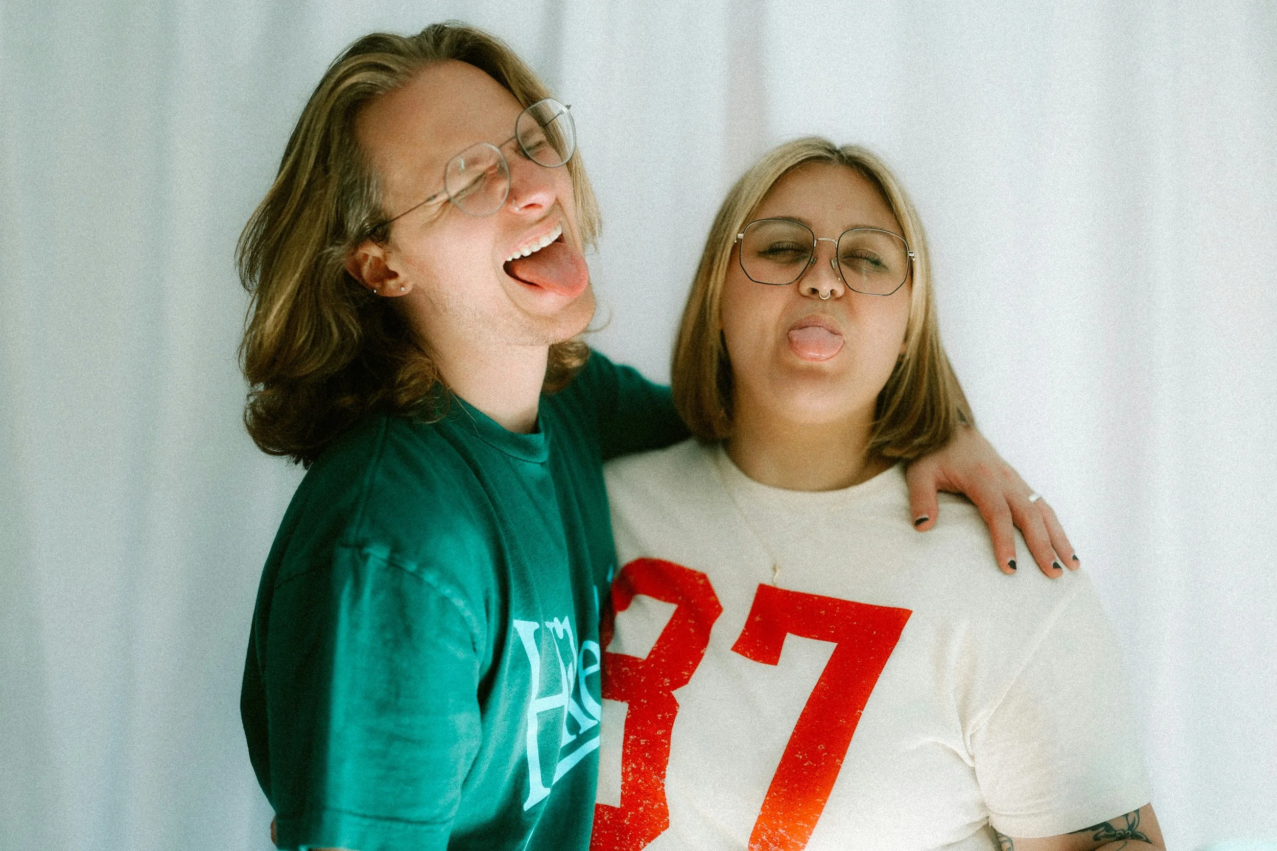 Two partners laughing and being playful together, representing connection, joy, and healthy relationships.