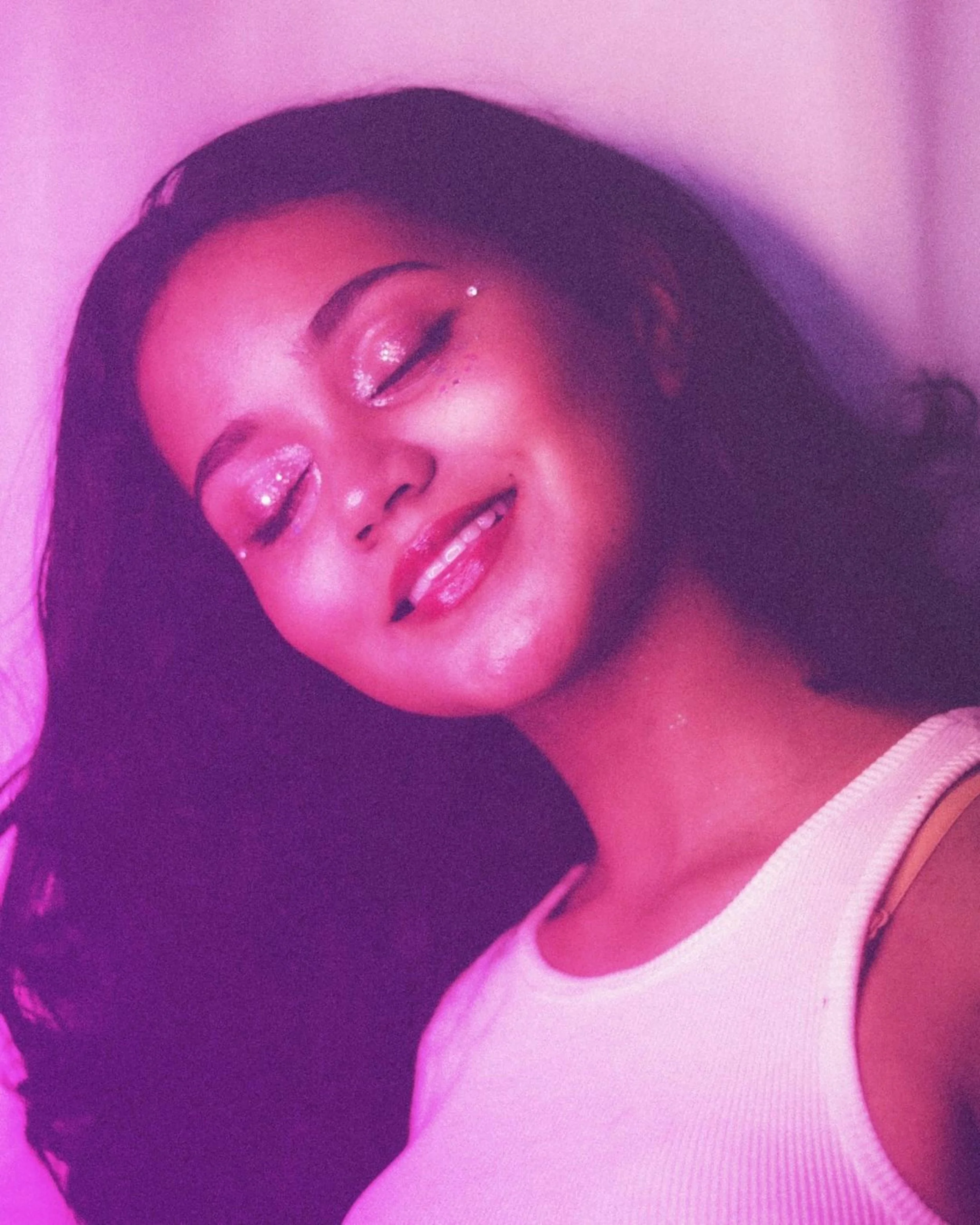 Woman with pink makeup and pink glitter on her face smiling, radiating joy and confidence, as therapist author describes her thoughts on the movie Legally Blonde