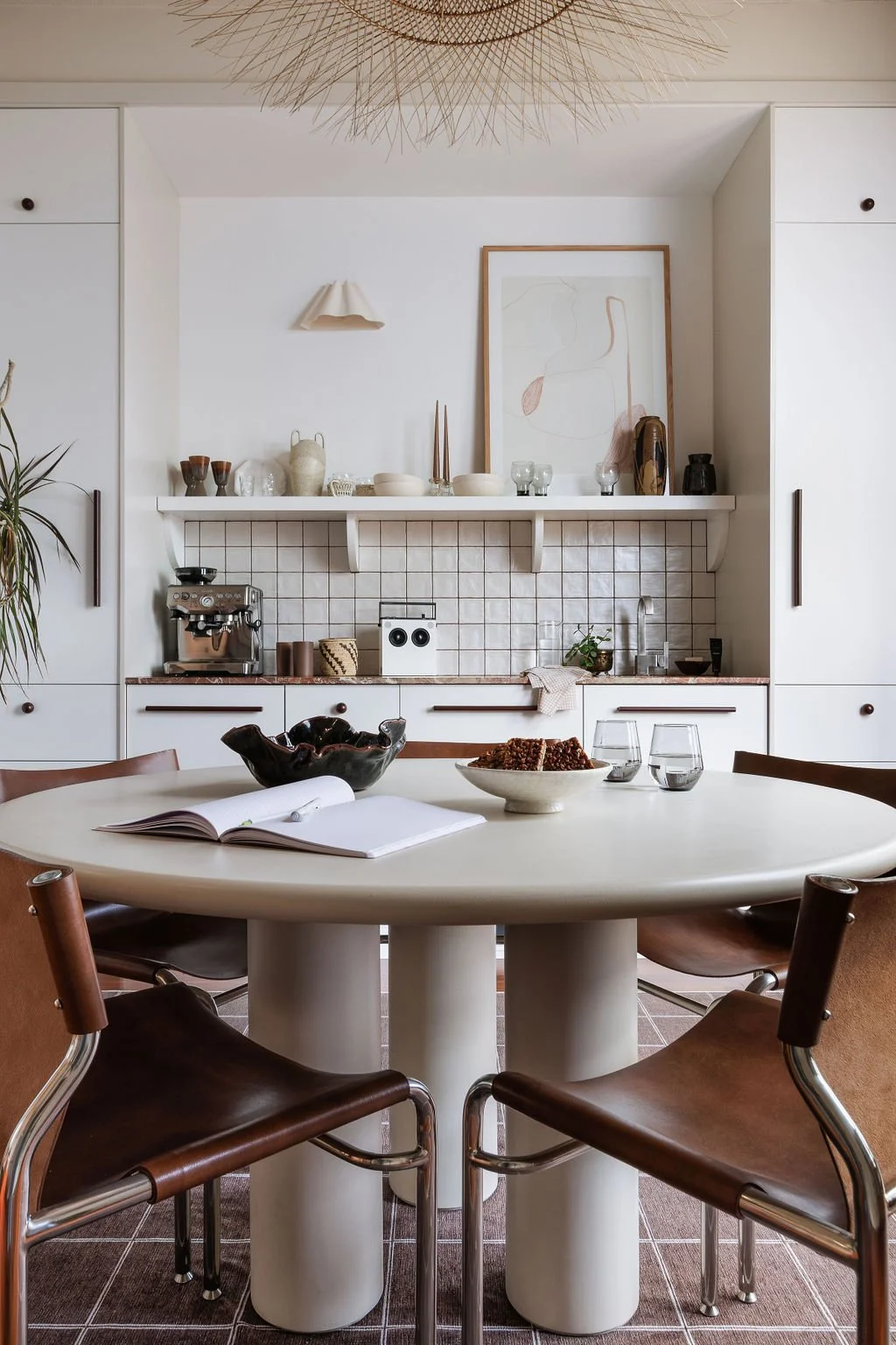 Office boardroom table with leather swig back chairs and coffee bar.