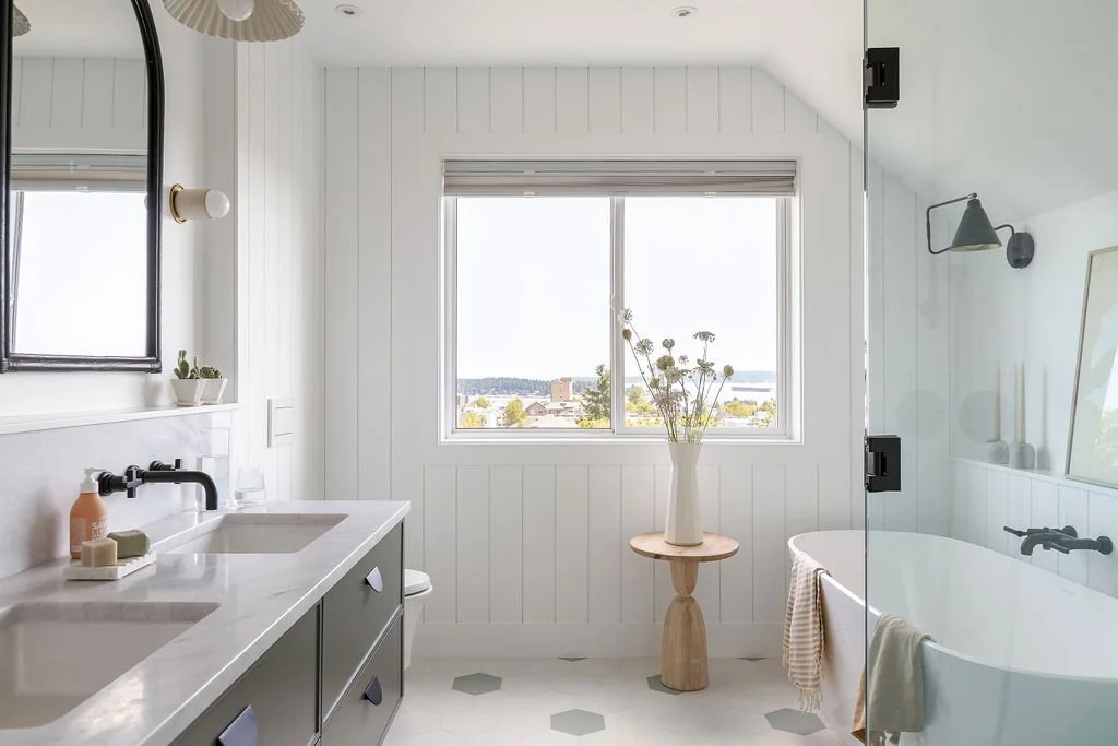 Side view of washroom vanity with view out to the city of Nanaimo out window.