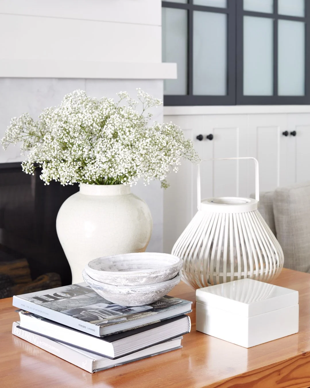 Photo of flowers and decor sitting on a coffee table.