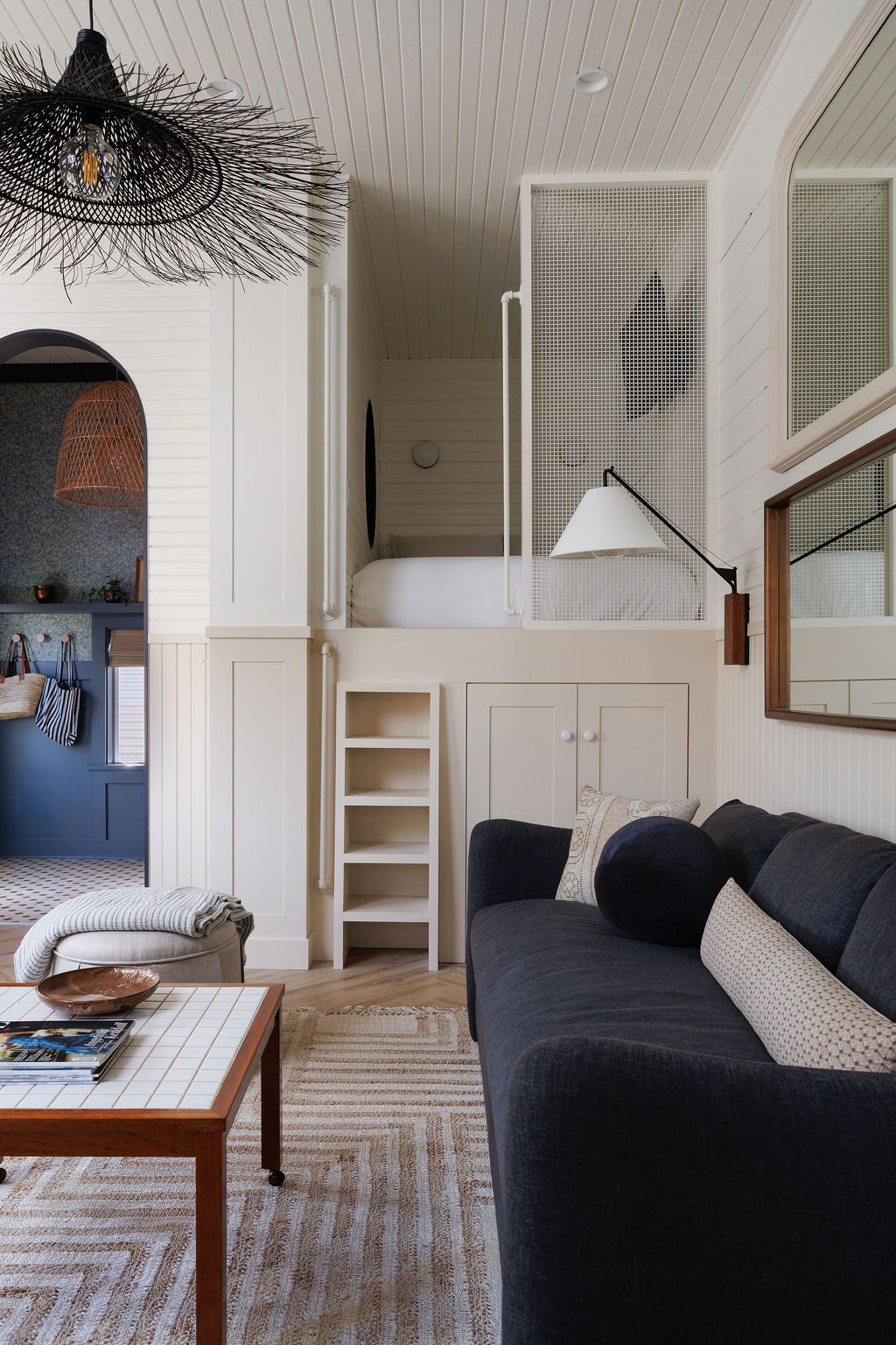 Selby Hotel living area with sofa bed, art on wall above and loft bed.