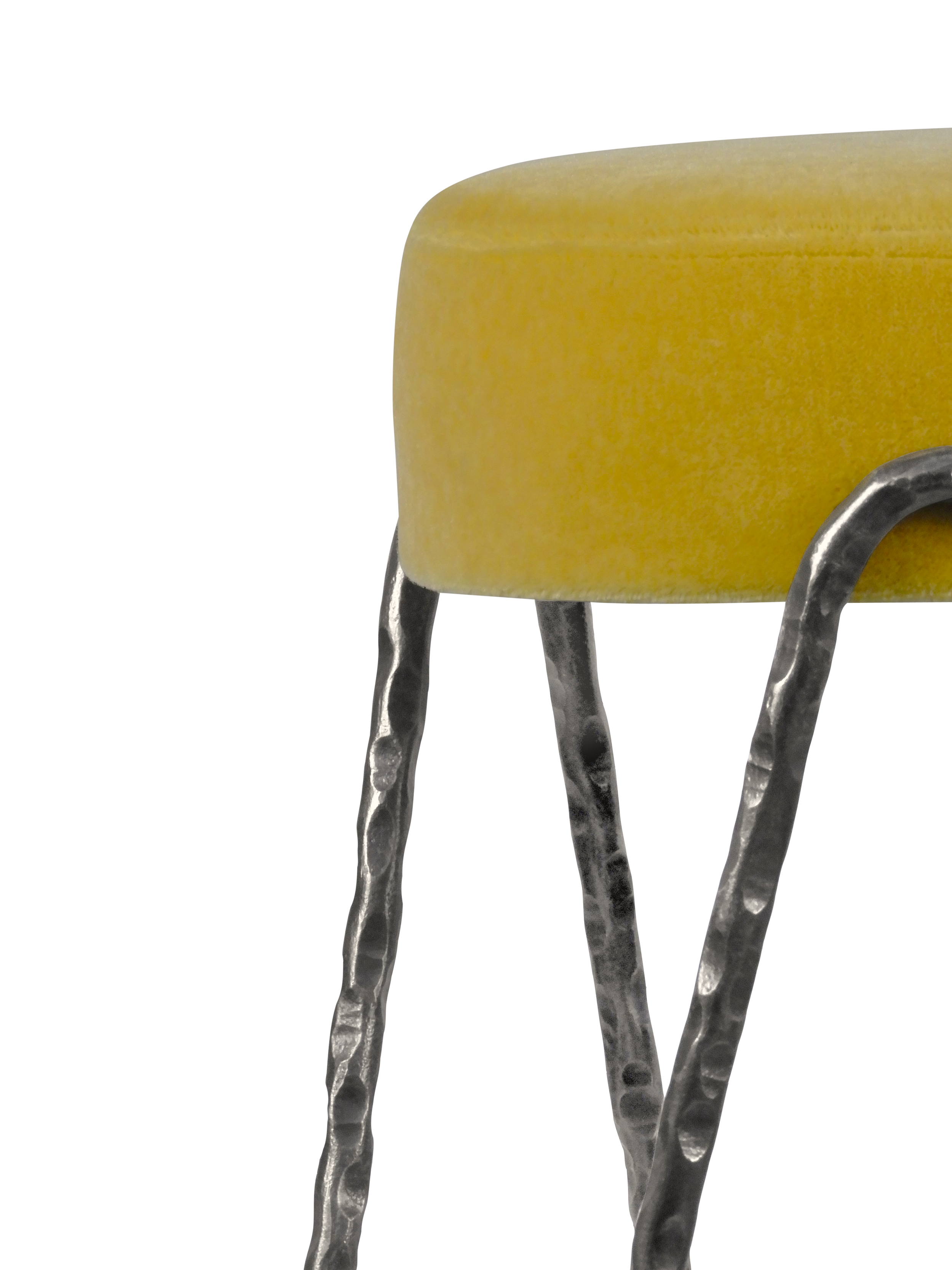 Close-up detail of the Aranea stool’s hand-hammered forged steel legs. Textured metal craftsmanship with custom patina and powder coat options for high-end interiors.