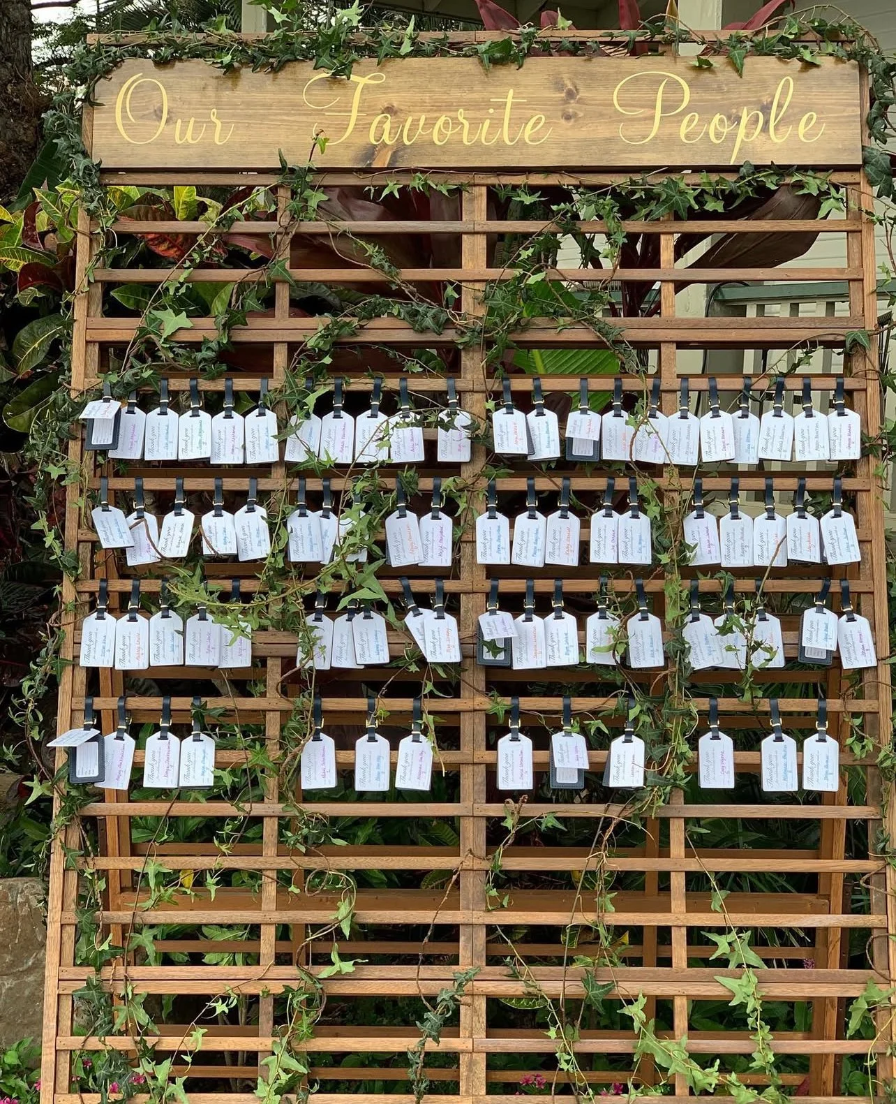 farmhouse-slat-wall-luggage-tag-seating-display-maui-wedding-decor.jpeg