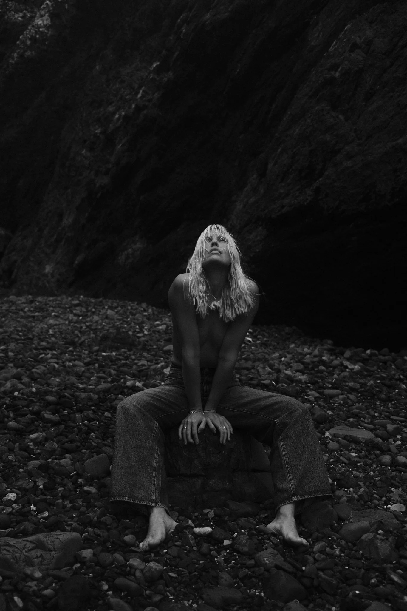 Editorial shot of Sonja Vahasaari modeling Wrangler flared jeans in a rocky location.