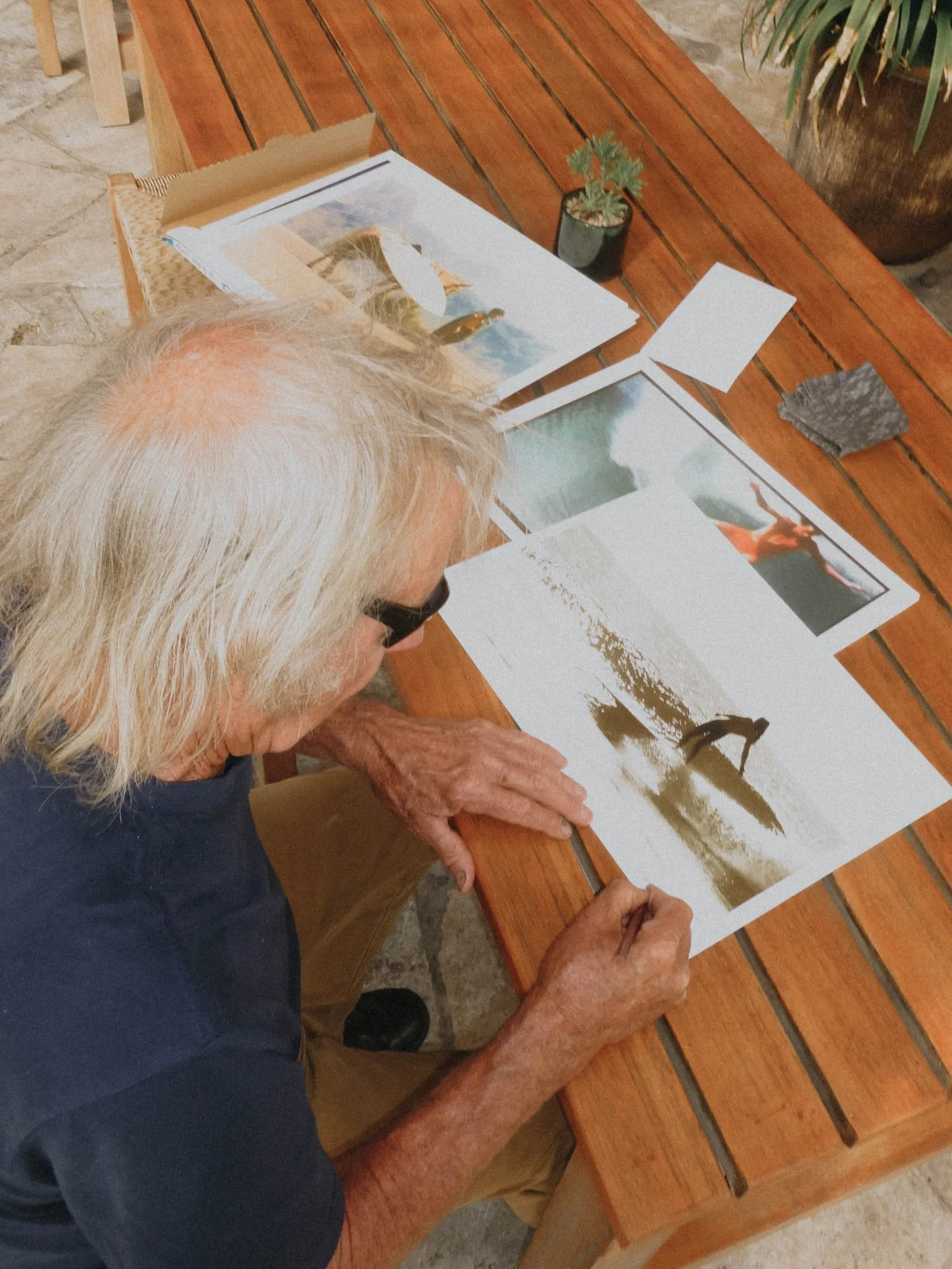 Albert Falzon signing his artwork for Sonja Vahasaari's Interconnectedness art exhibition.