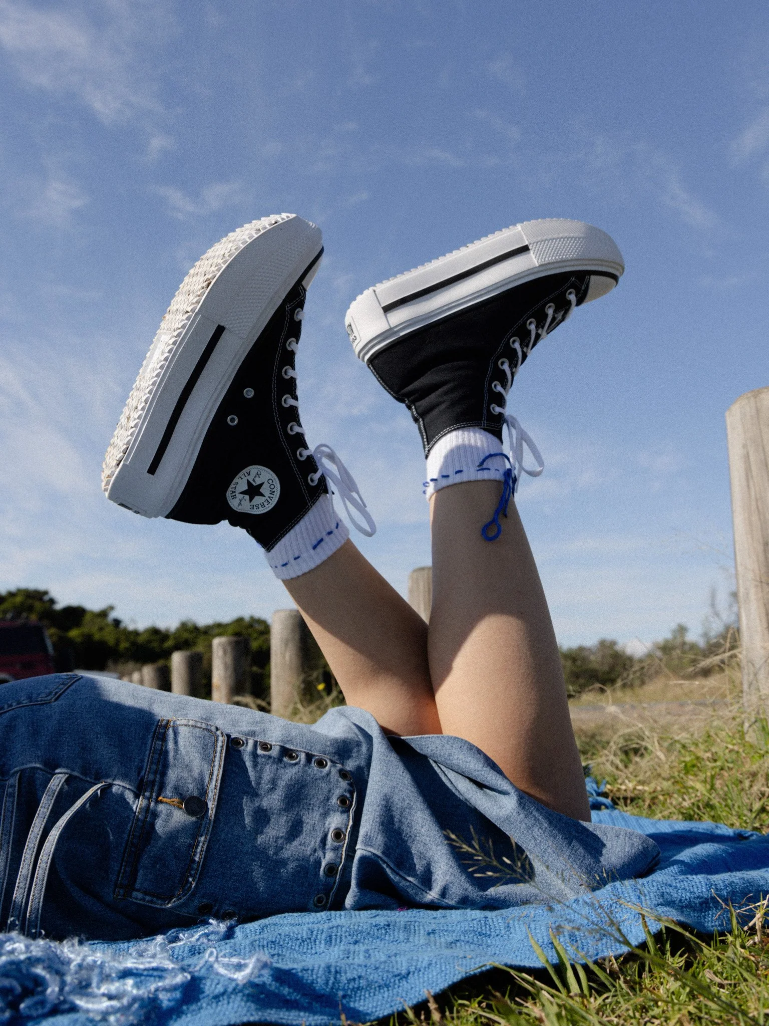 Close-up of Sonja’s Converse high tops styled with her unique style.
