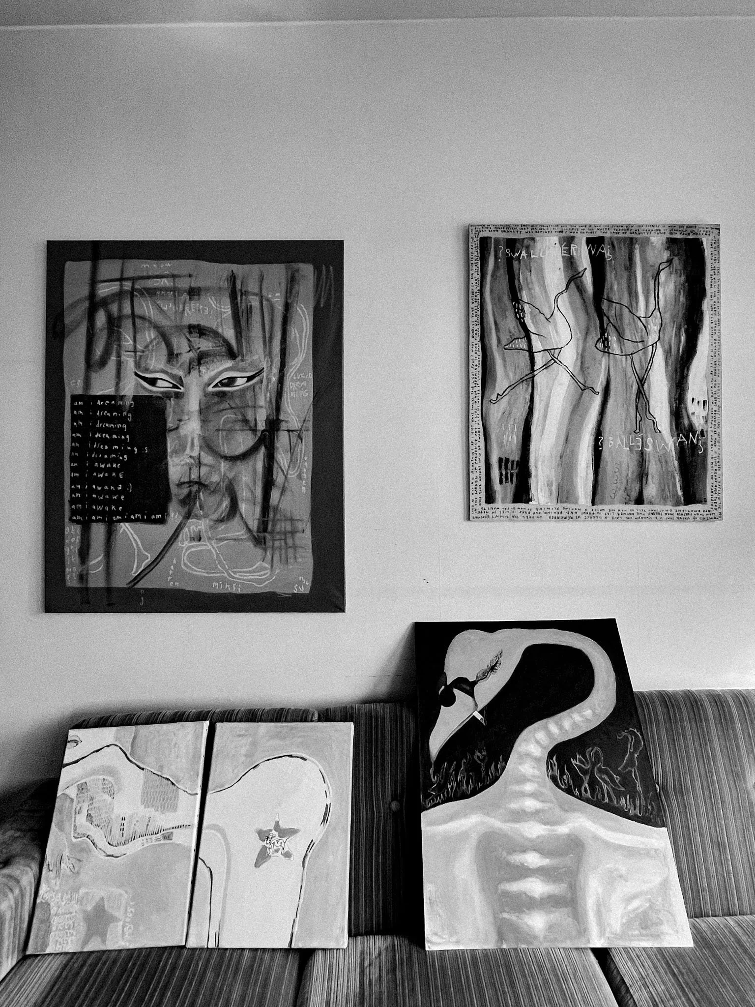 Sonja Vahasaari's paintings in a living room.