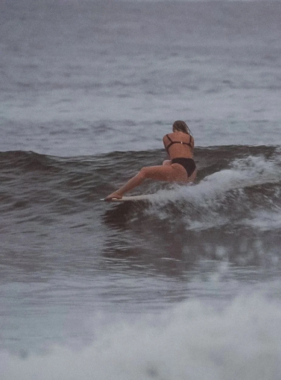 Sonja Vahasaari surfing wearing jewellery.