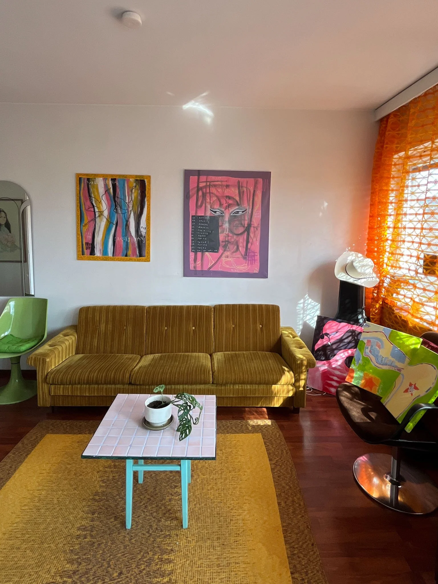 Sonja Vahasaari's paintings in a living room.