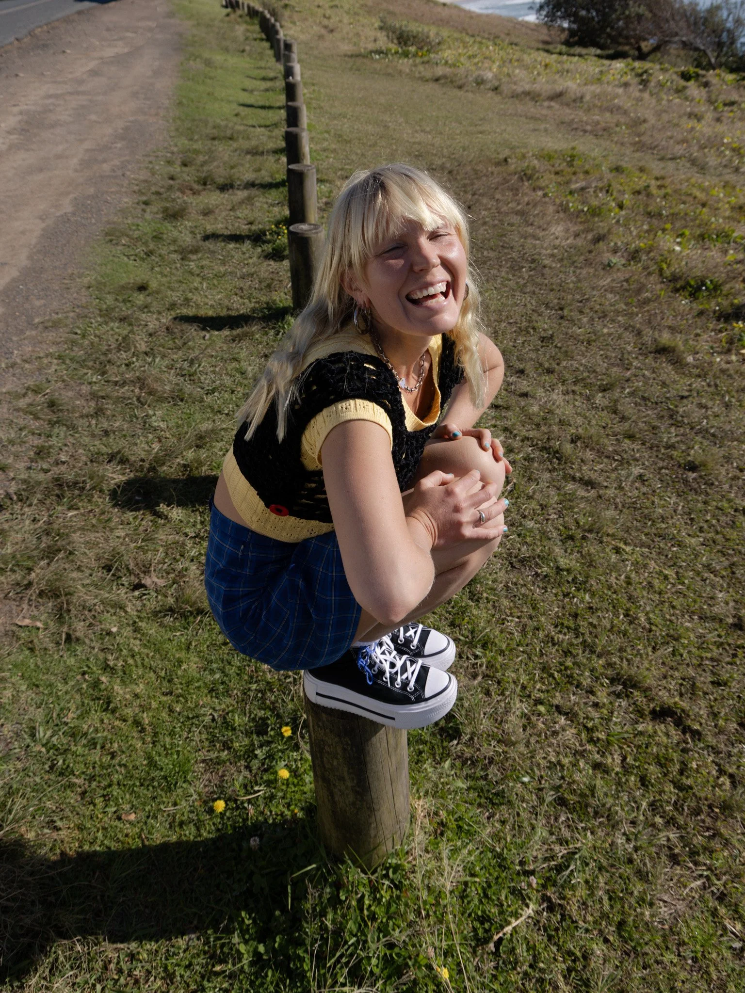 Sonja Vahasaari modeling Converse sneakers laughing joyously.