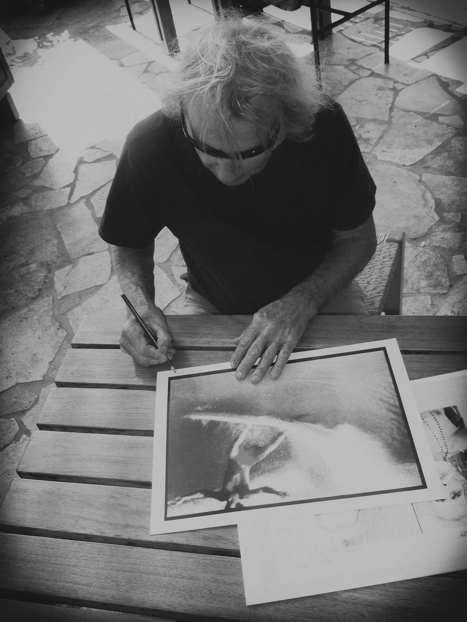 Albert Falzon signing his artwork for Sonja Vahasaari's Interconnectedness art exhibition.