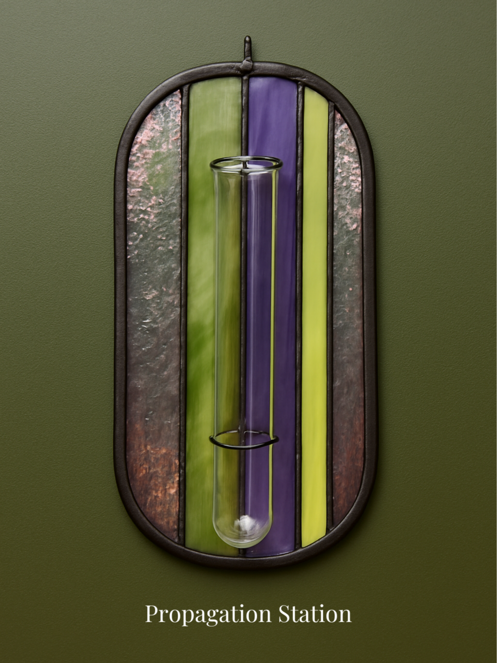 Colored stained glass art with a glass test tube attached, titled Propagation Station.