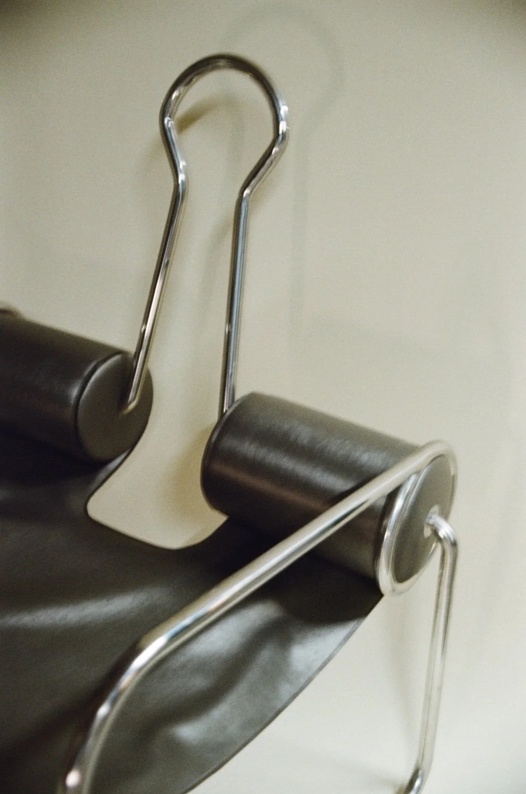 Black leather paper clip chair with inspiration from Marcel Breuer's Wassily B3 Armchair