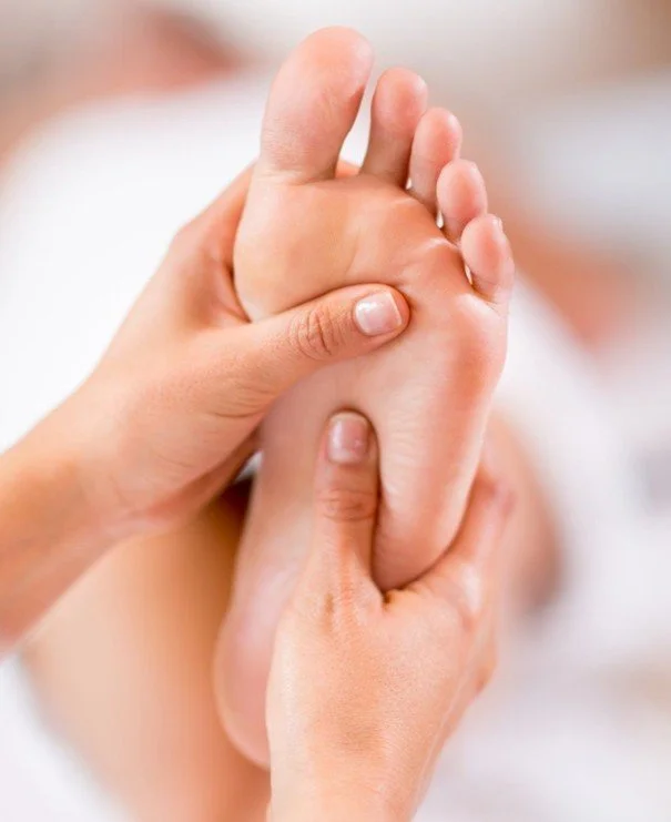 Twee mensen die elkaar een voetmassage geven.